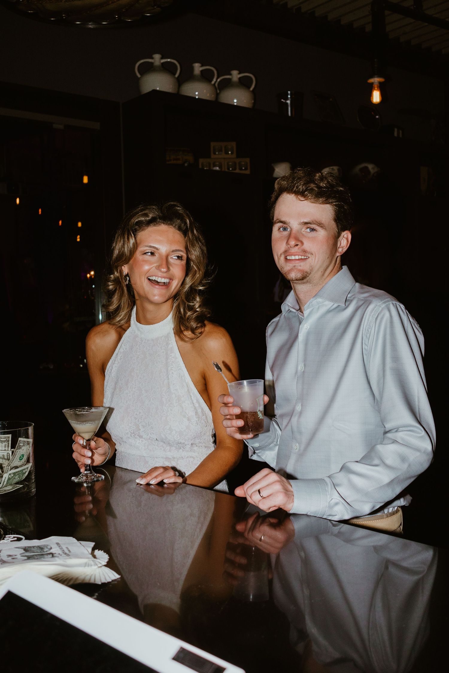 Bride and groom cheering drinks