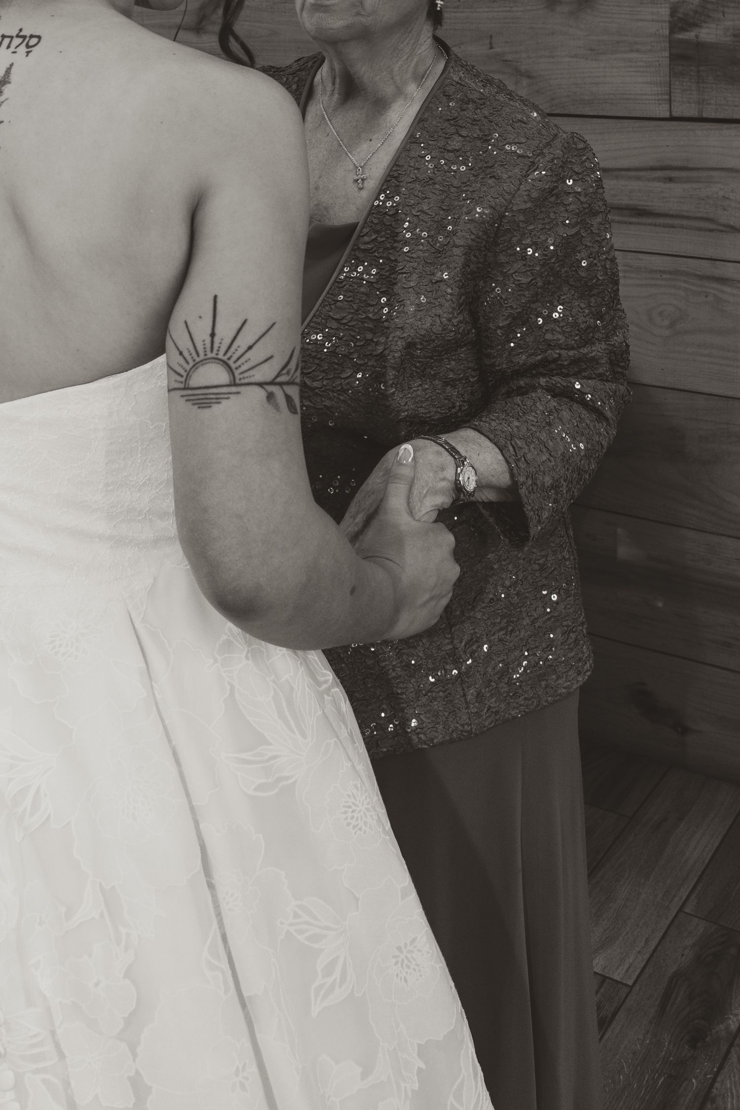 Black and white photograph of the bride holding her grandmothers hands
