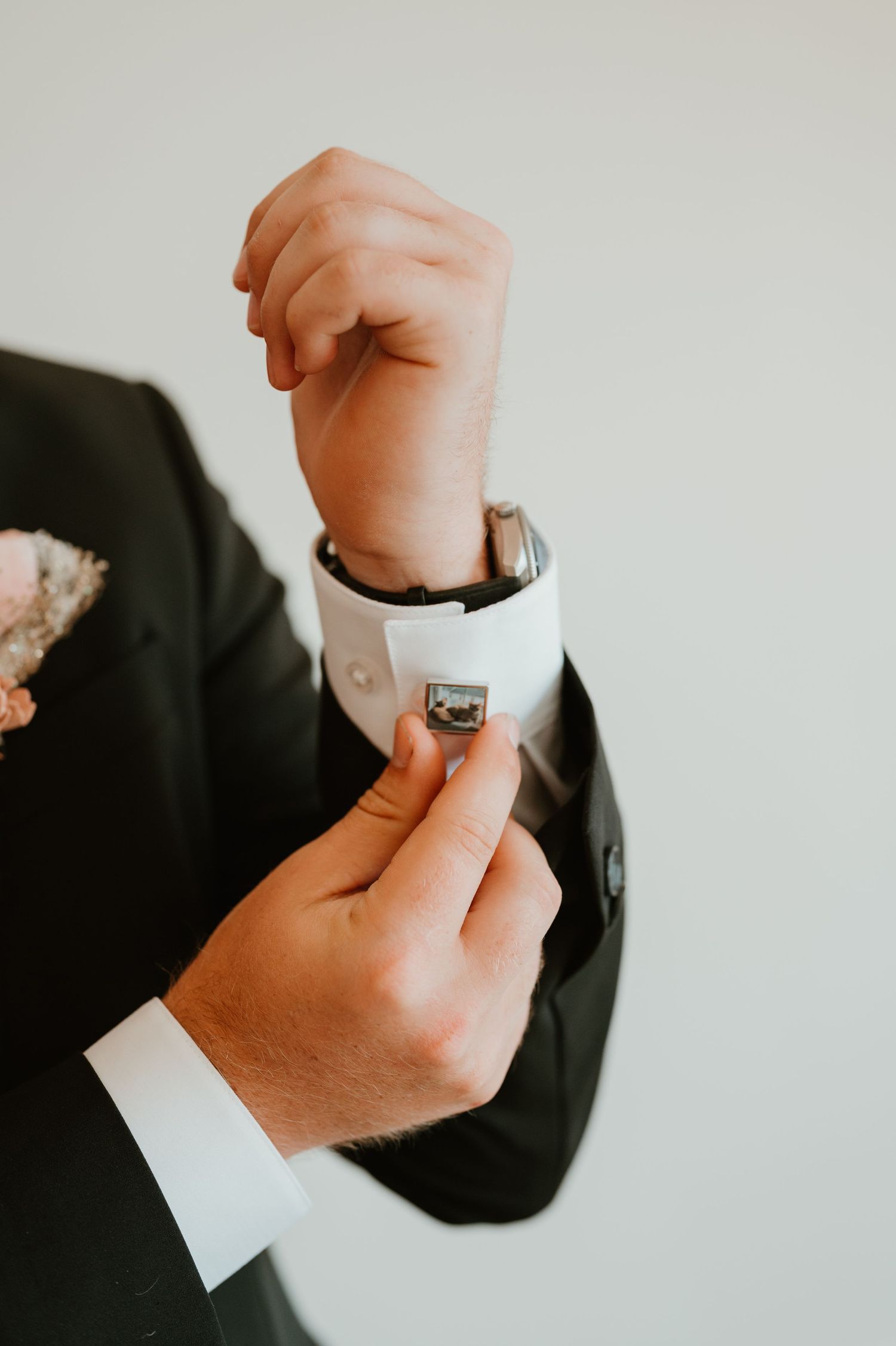 detail picture of the grooms cuff that has a picture of his cat on