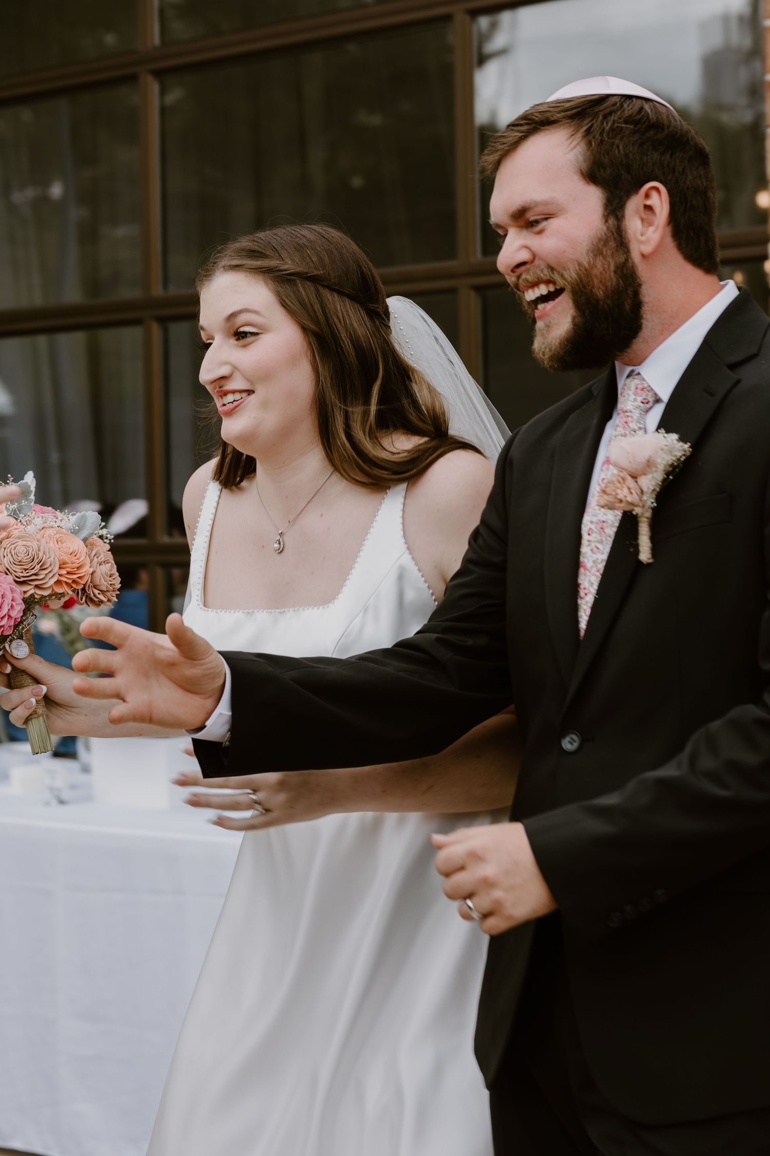 couple walking down the isle to grab their drinks with cozies with their cats on them