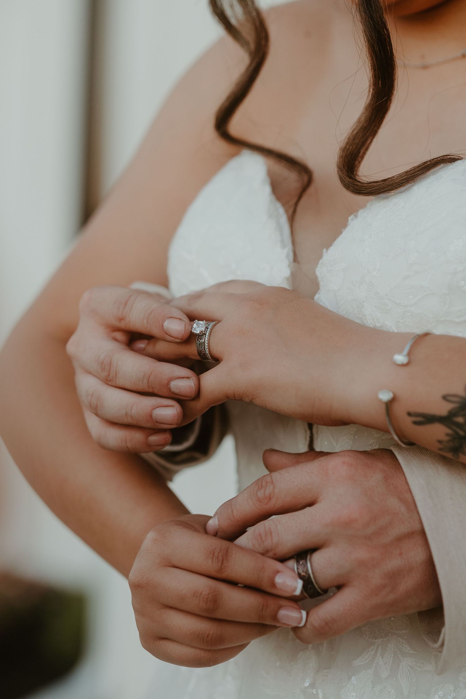Bride and groom placing rings on fingers. Detail shot.