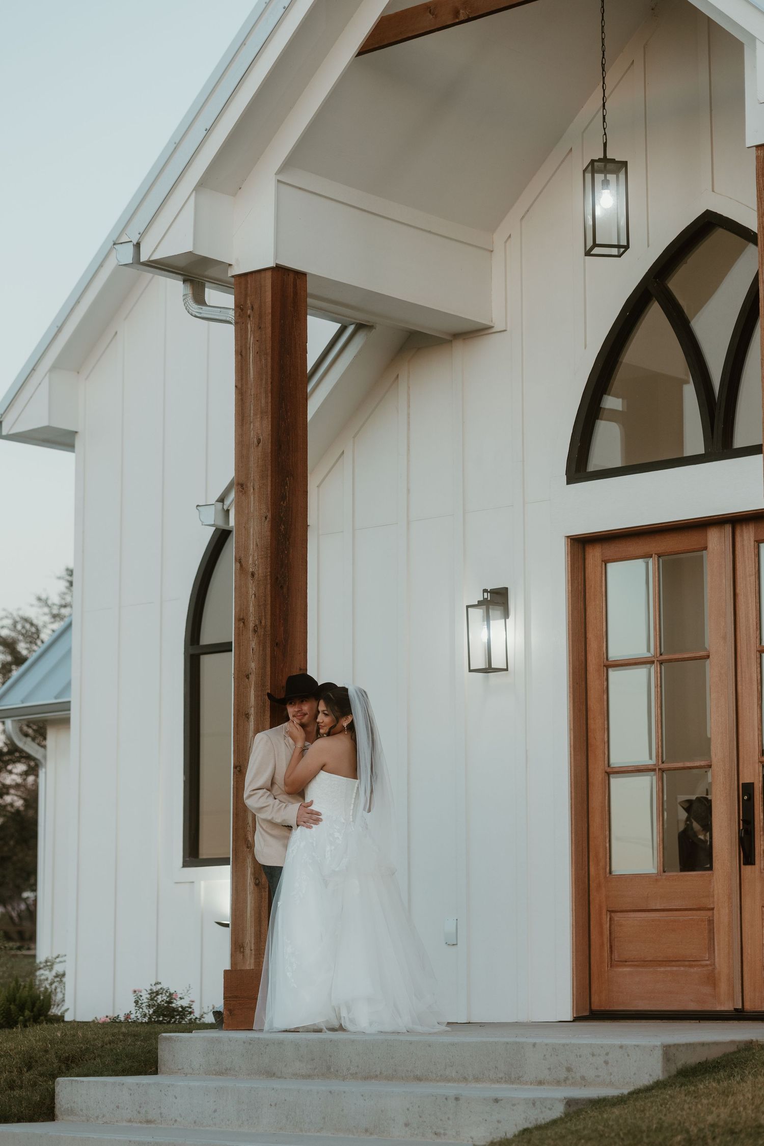 Bride and groom in front of the deerfield estates chapel in central Texas.