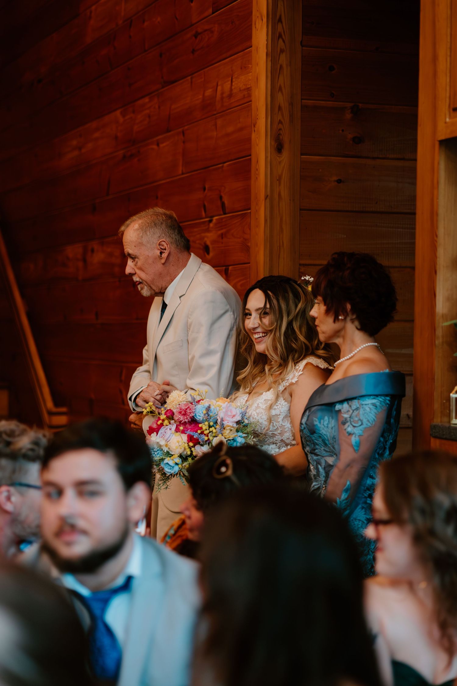 Bride walking down the isle with both parents to see the groom
