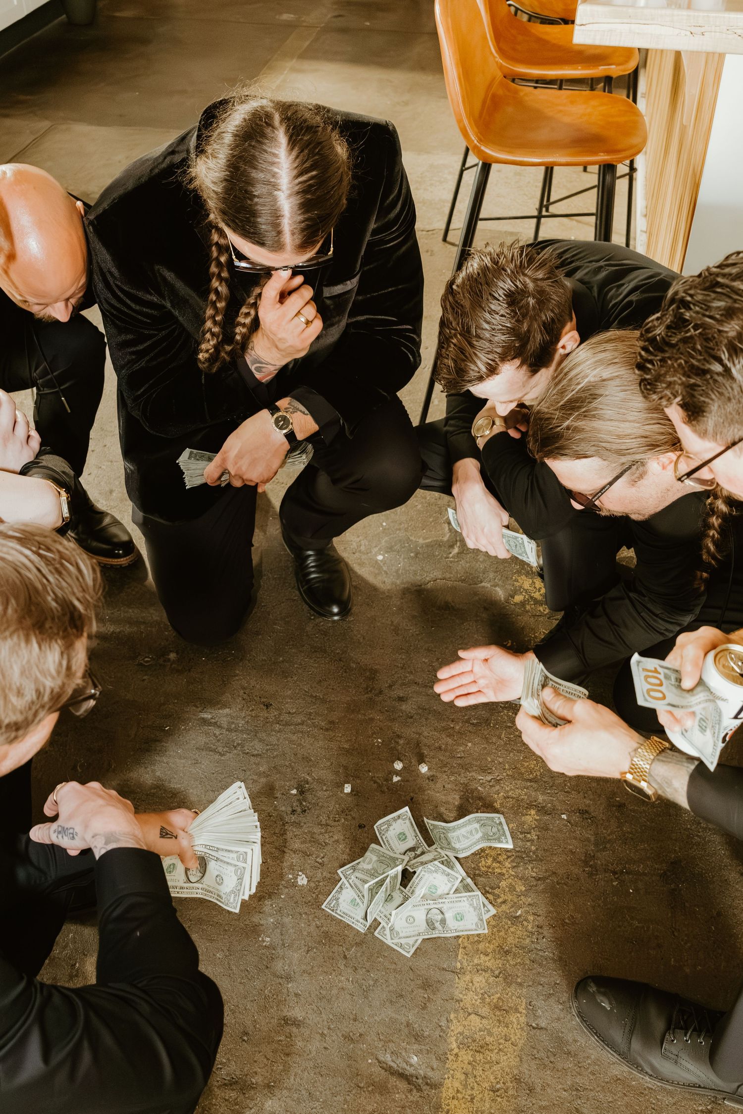Groomsmen playing dice together before the wedding ceremony