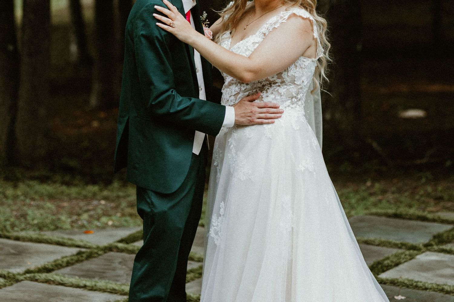 Bride and groom standing together outdoors holding hands after the ceremony