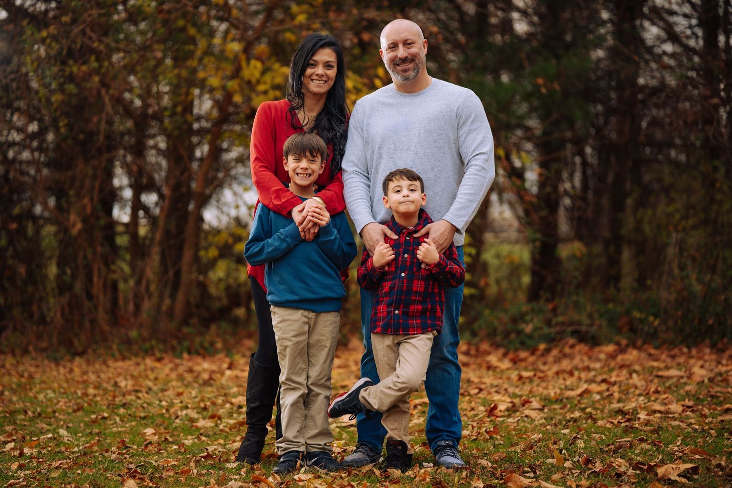 Family spending time together outdoors during autumn season.
