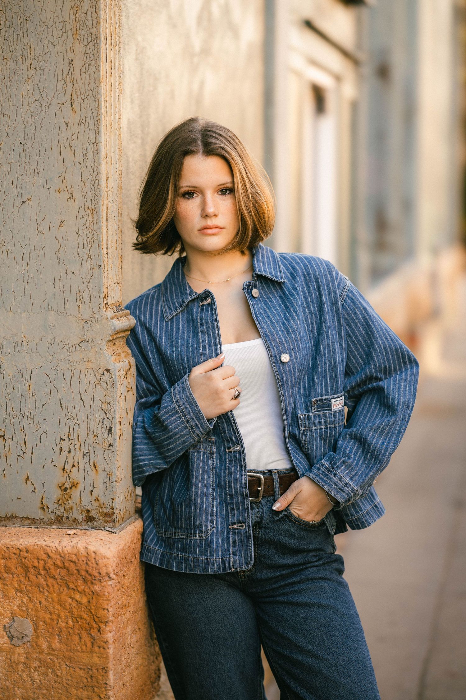 Senior portrait of a young woman next to a rustic building in historic Stillwater Minnesota