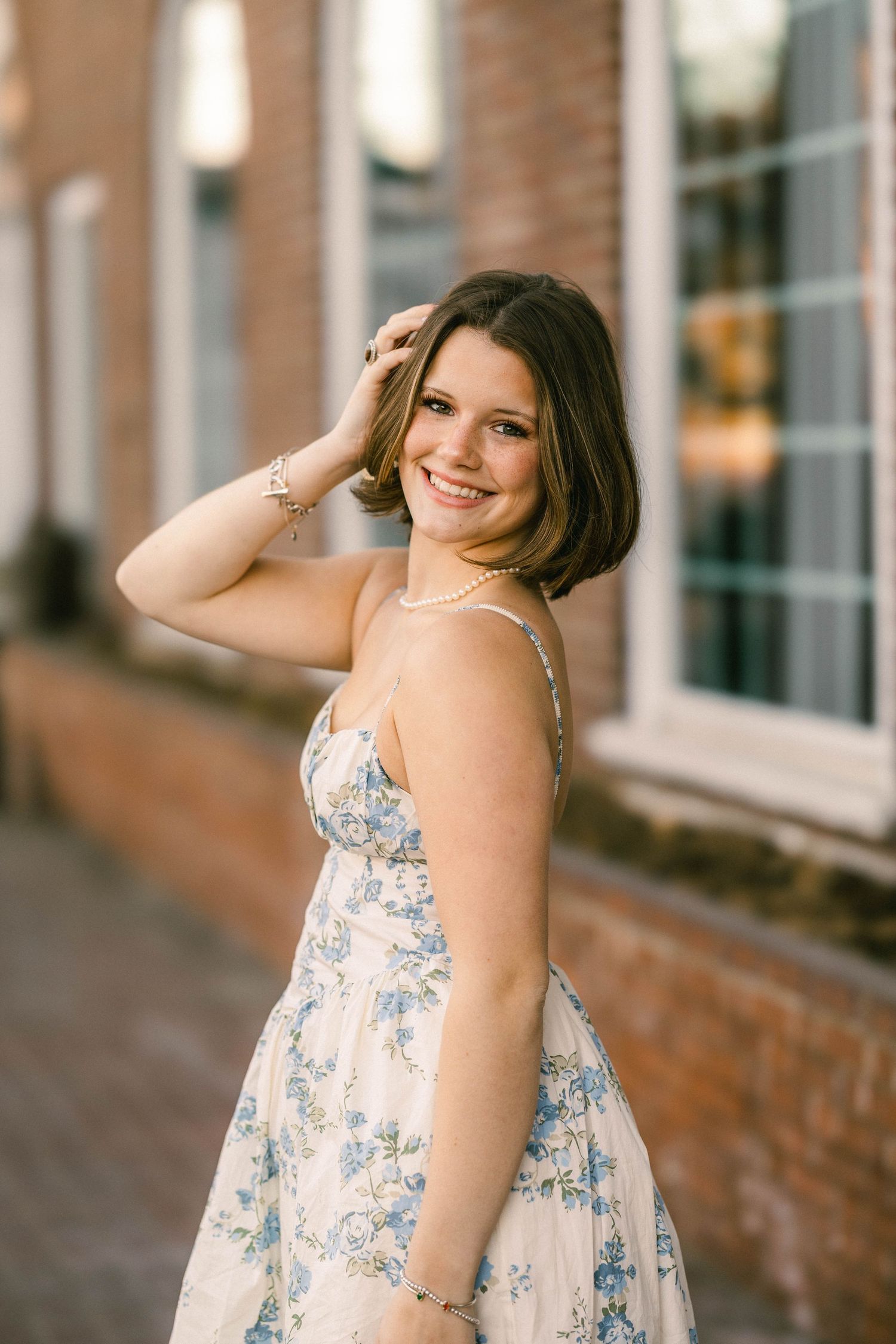 Timeless senior photo with a filmic feel of a young woman outside a historic brick building in Stillwater Minnesota