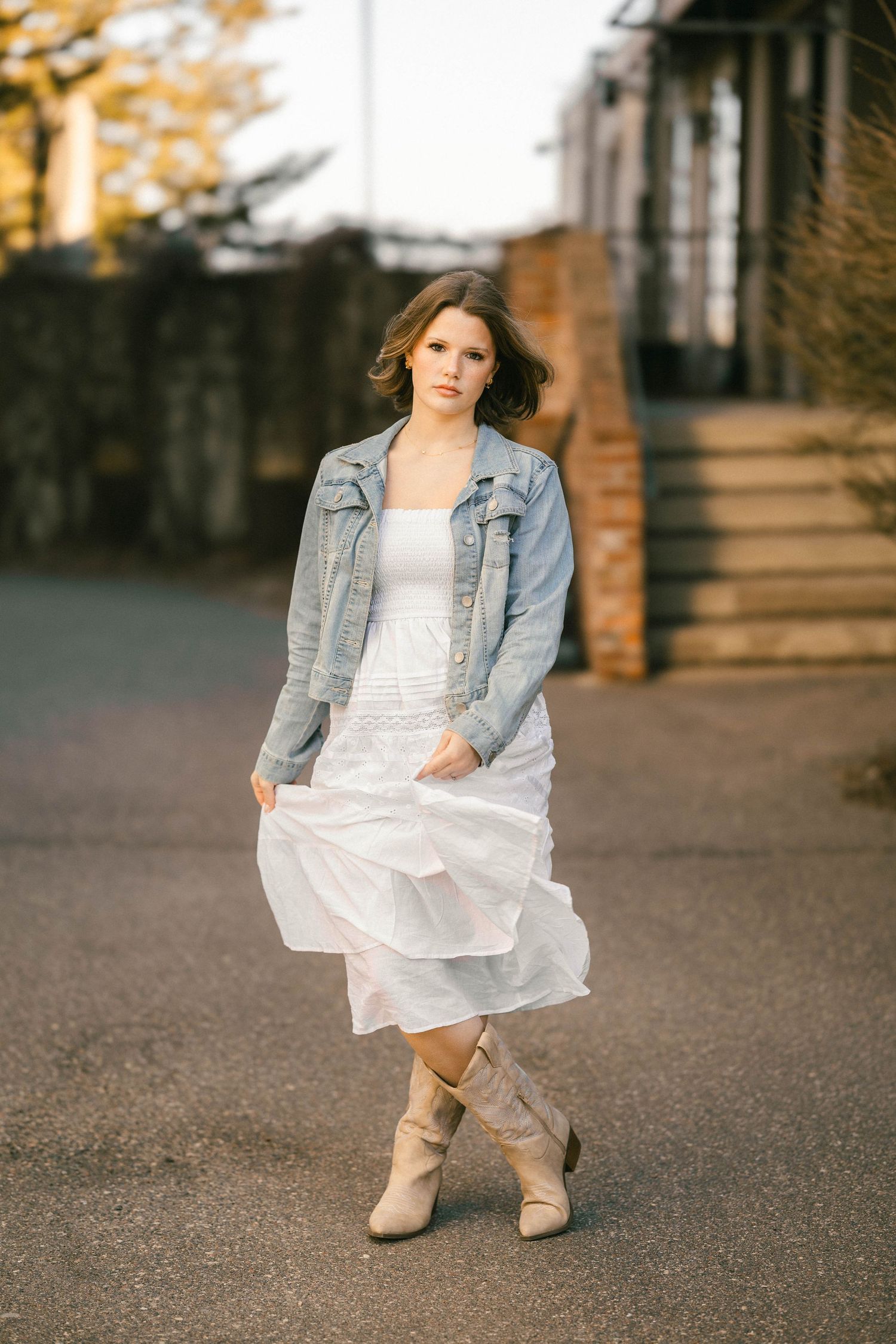 Senior portrait of young woman standing in front of brick stairs in downtown Stillwater Minnesota
