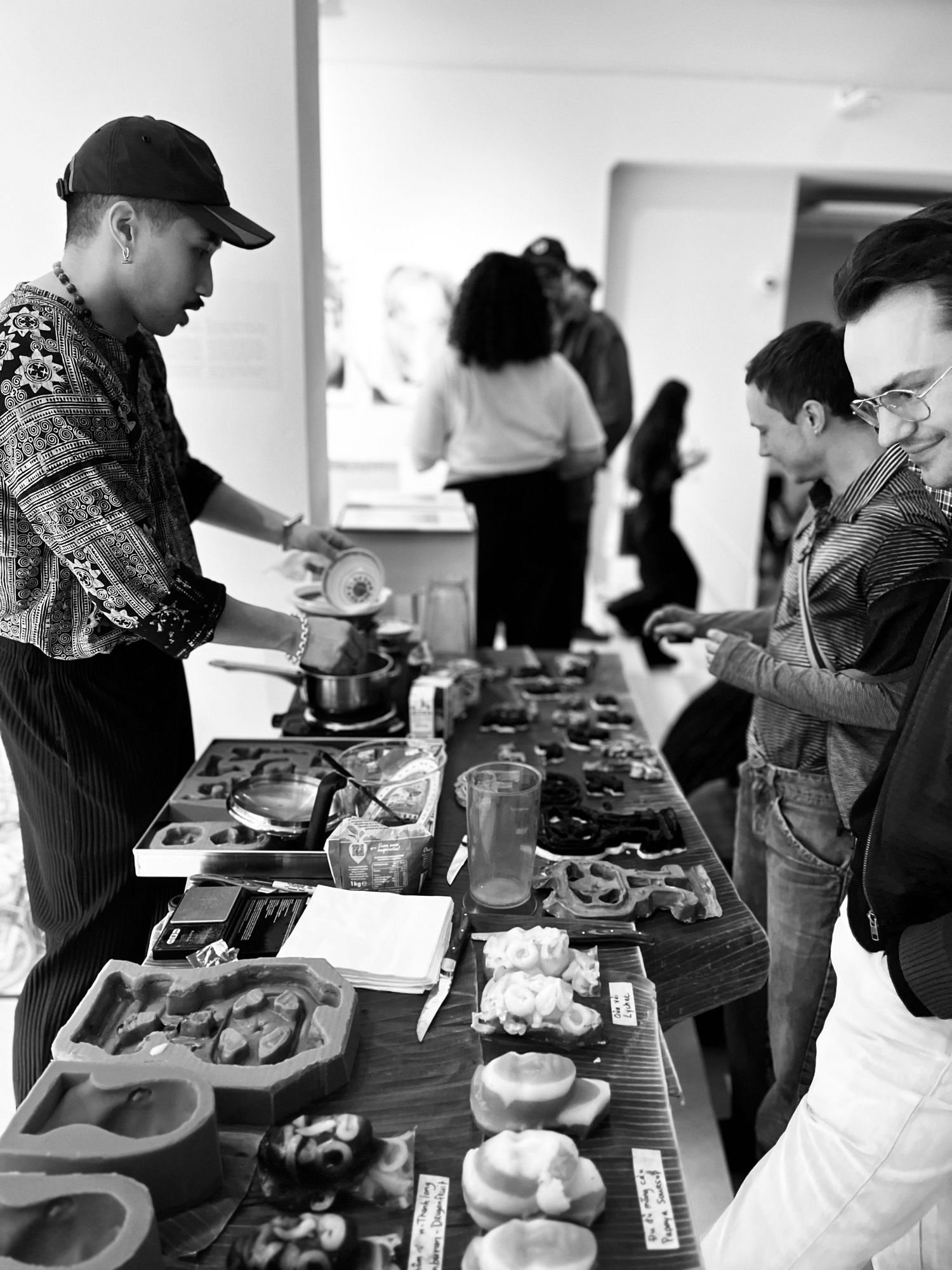 Creators engaging visitors in gallery space, authentic professional photography