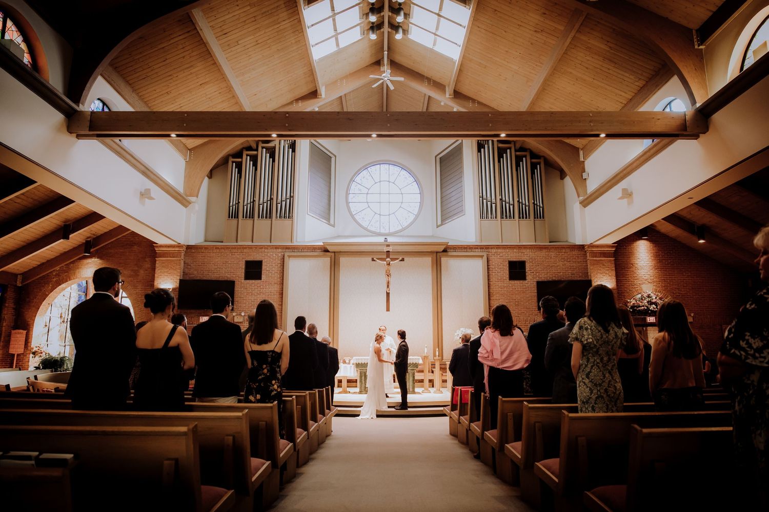 Interior view of a traditional church sanctuary with wooden pews and natural lighting.