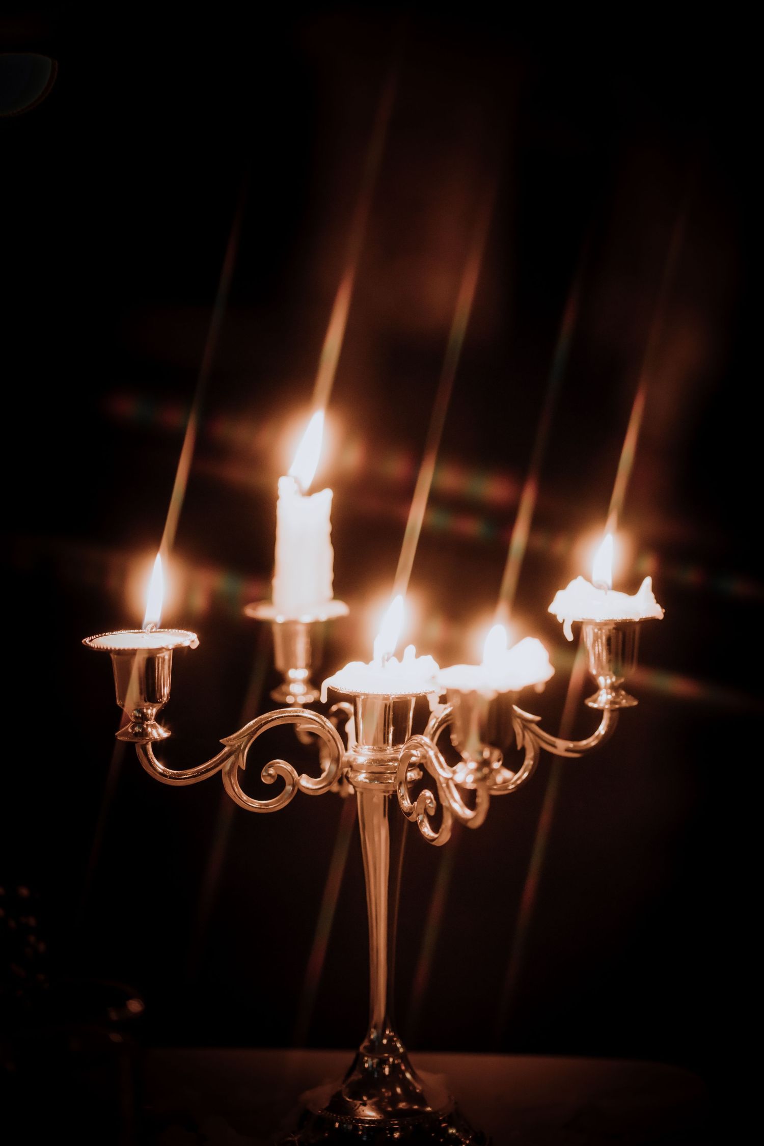 Ornate candelabra with multiple lit candles creating a romantic ambiance.