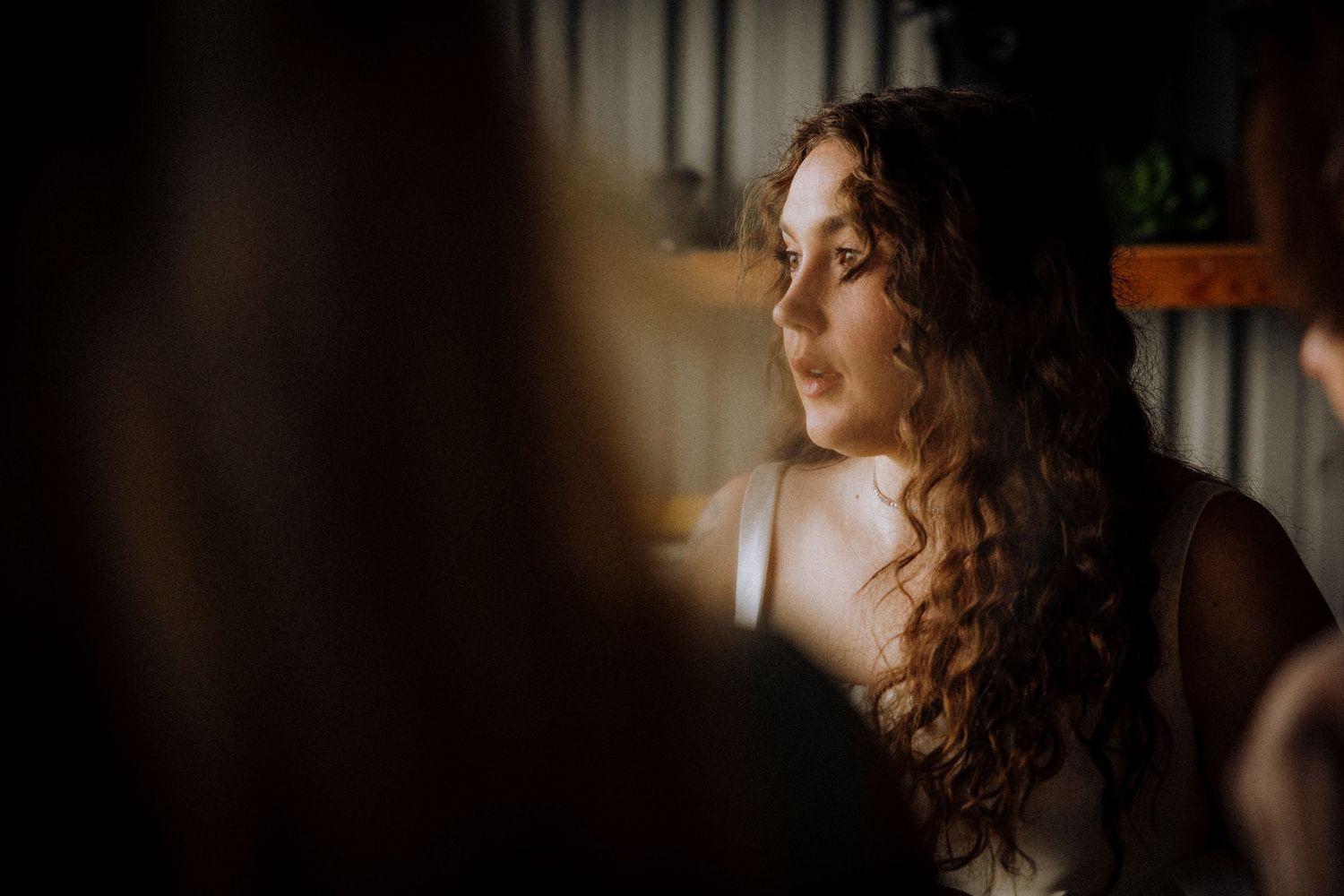 Artistic low-light portrait captures a romantic wedding moment.