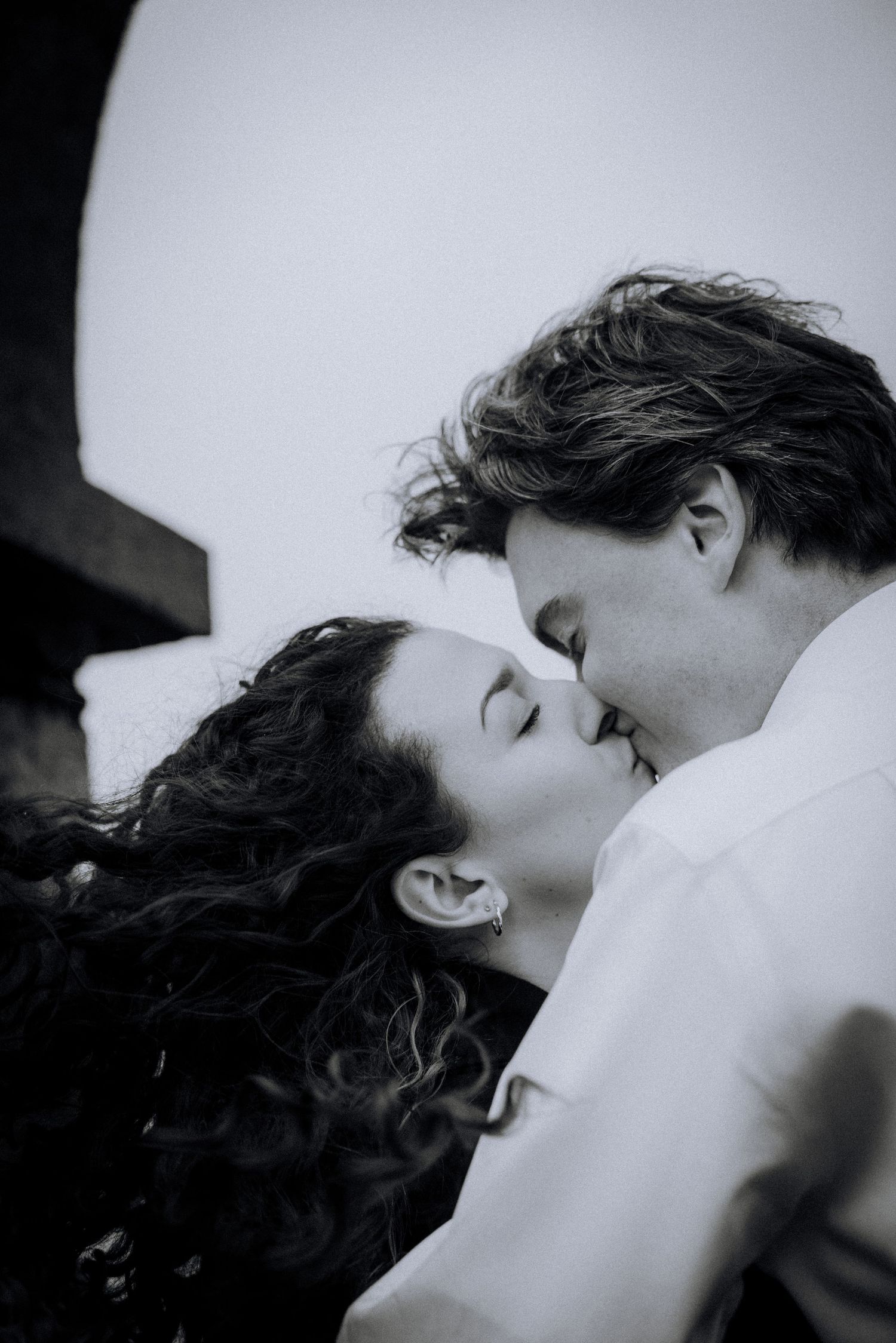 Intimate black and white portrait sequence showing tender romantic moments between a couple.