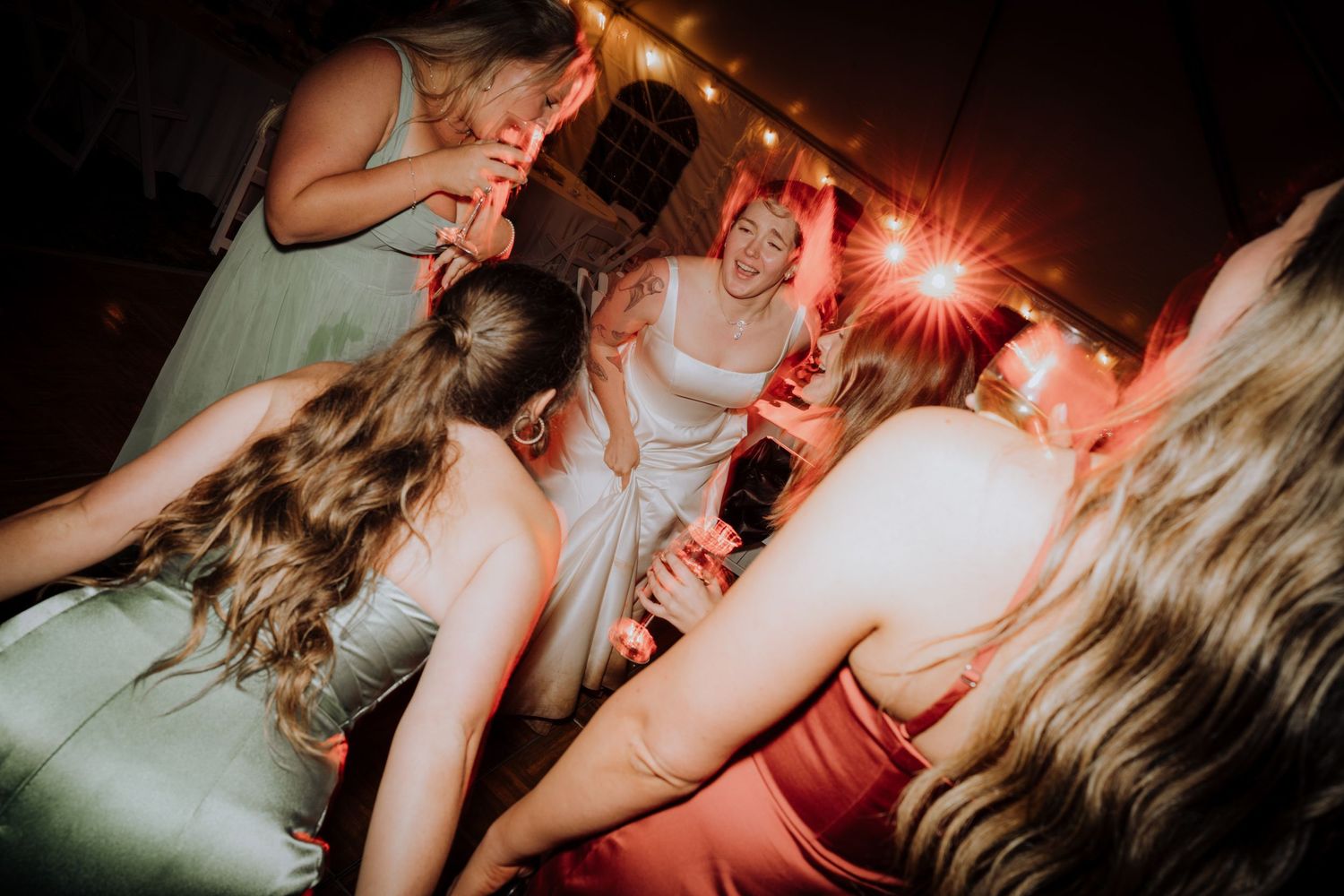 Wedding reception party scene with dancing and sparklers creating a festive atmosphere.
