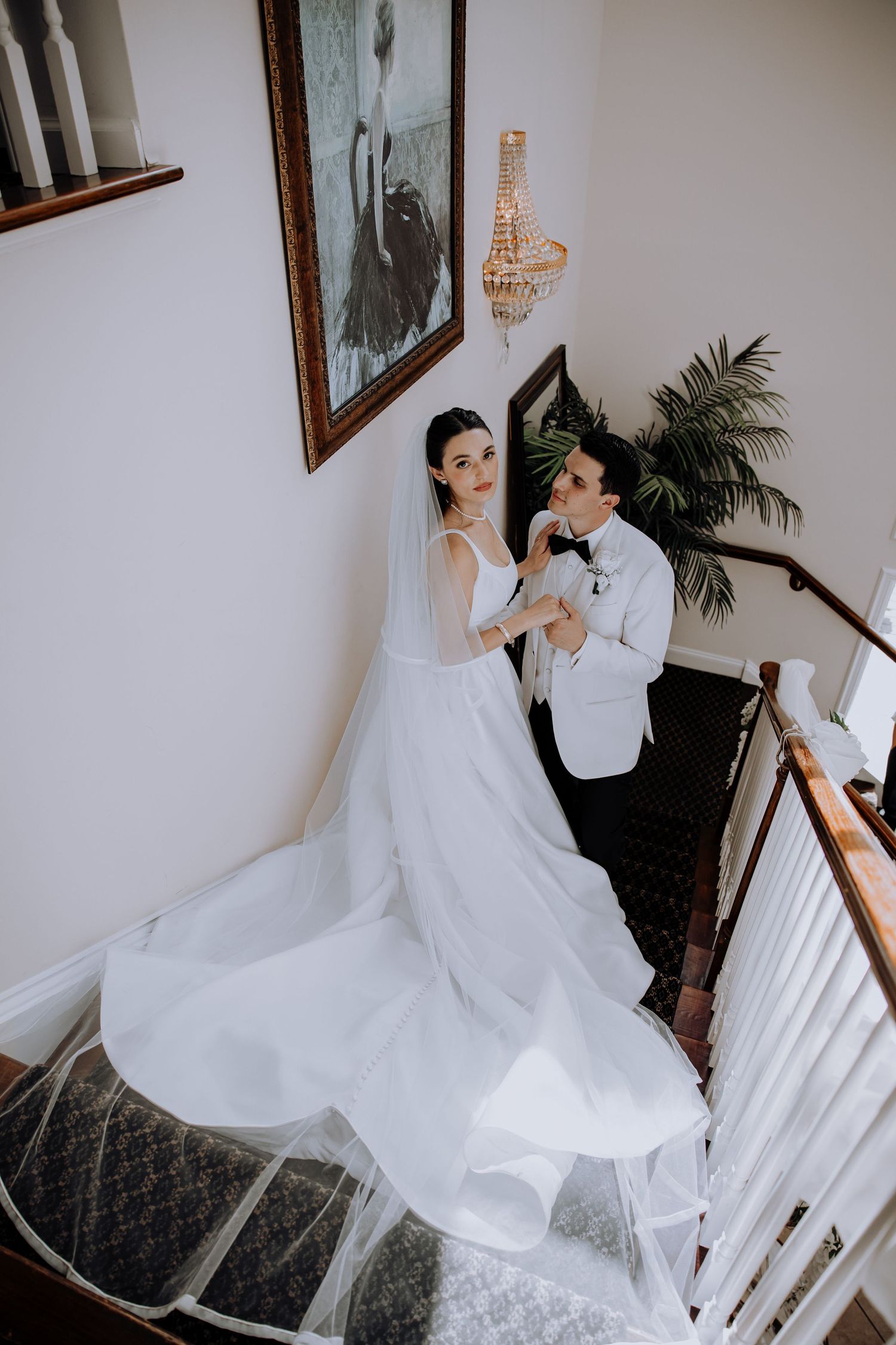 Dramatic wedding photography sequence on an elegant indoor staircase.