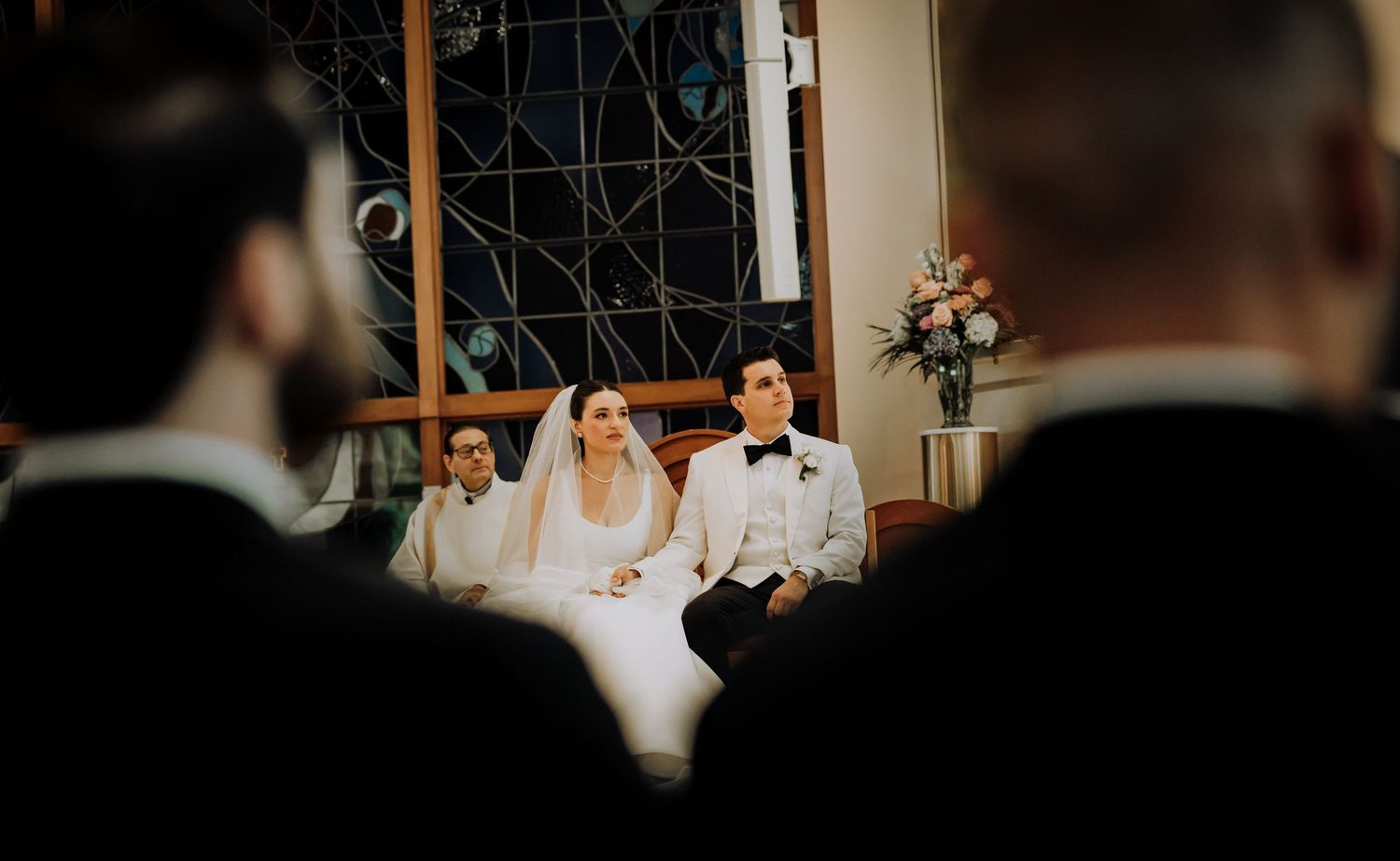 A romantic wedding couple shares intimate moments in a series of dark and moody indoor photographs.Editorial and Cinematic Wedding photos