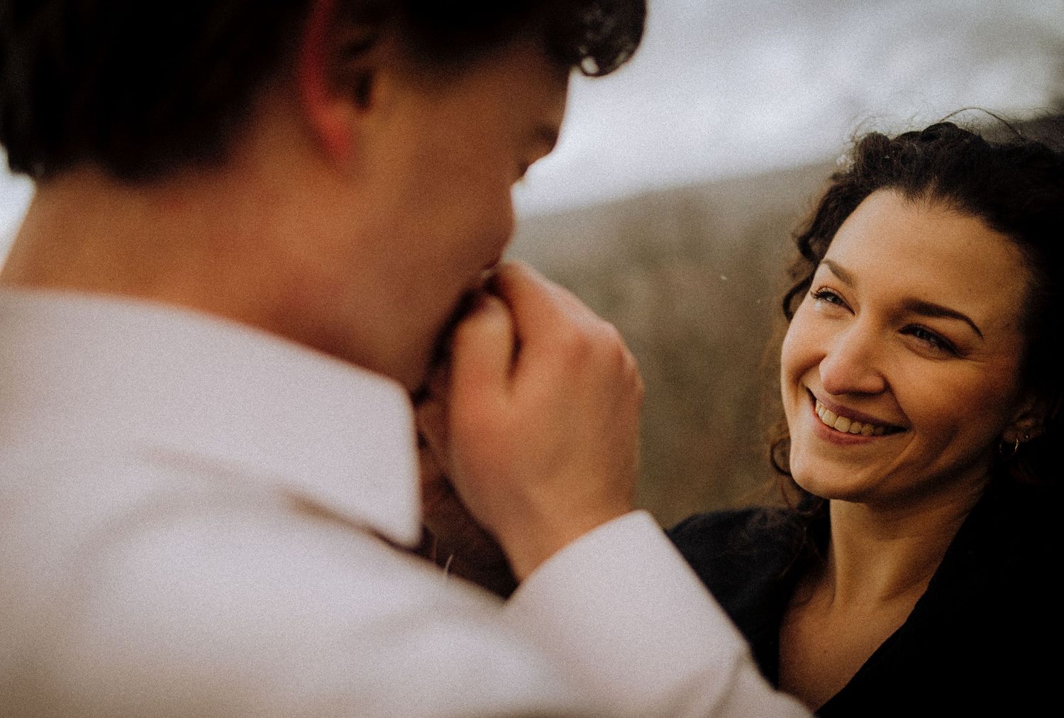A tender romantic moment captured between a couple in warm lighting.