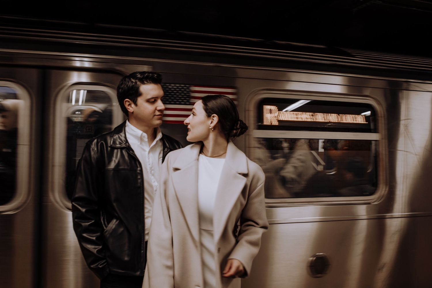 Intimate moment captured in a vintage subway car with moody lighting.