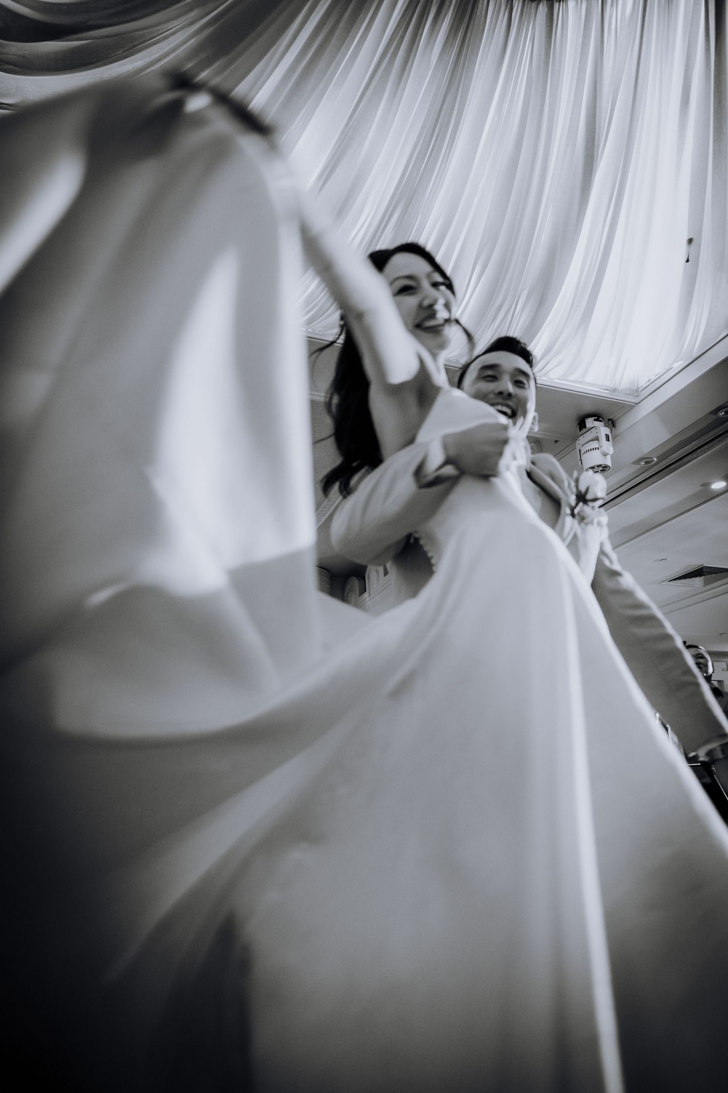 Artistic black and white sequence showing flowing white fabric against a light background creating ethereal movement.