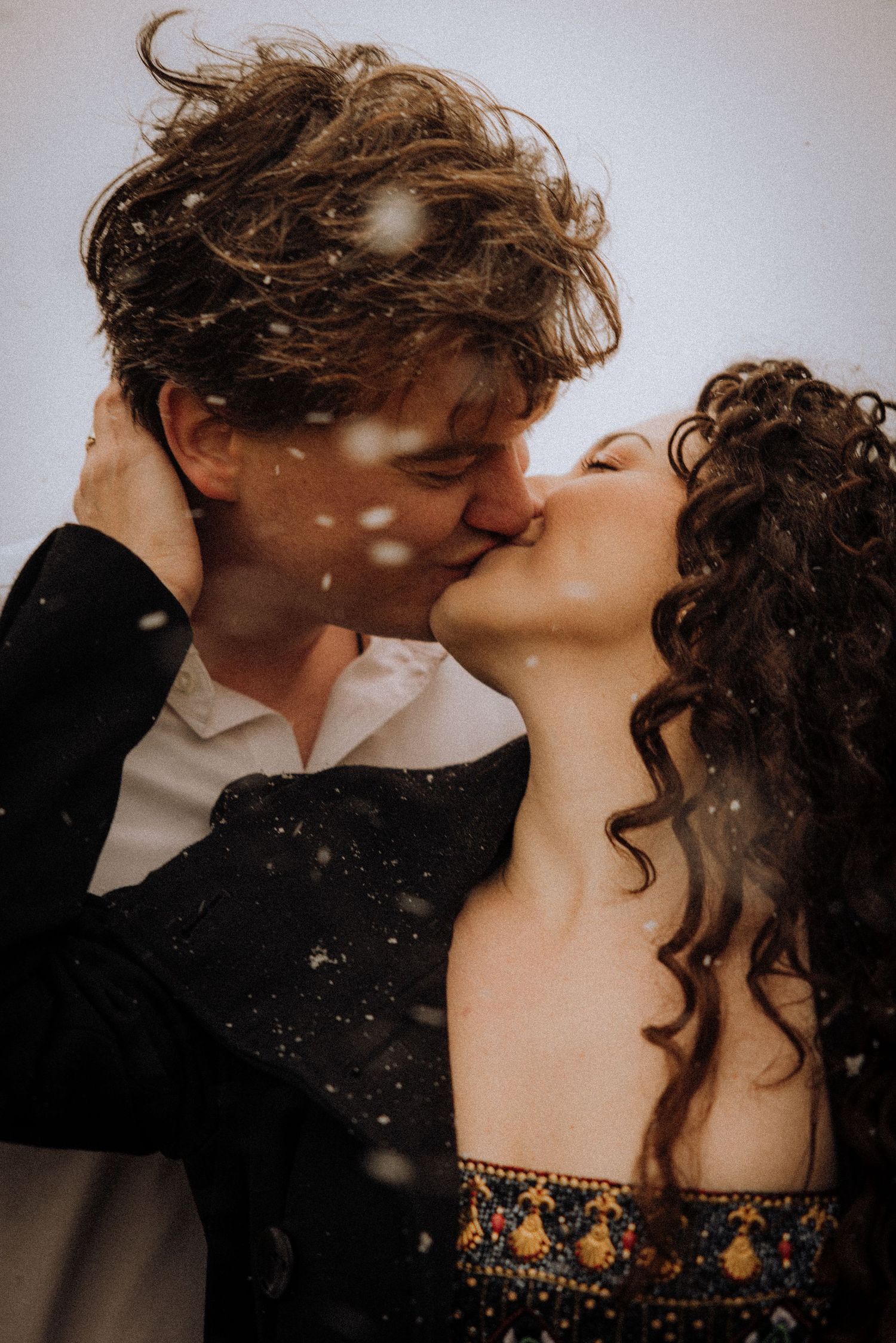 Romantic couple sharing an intimate dance moment in formal attire.