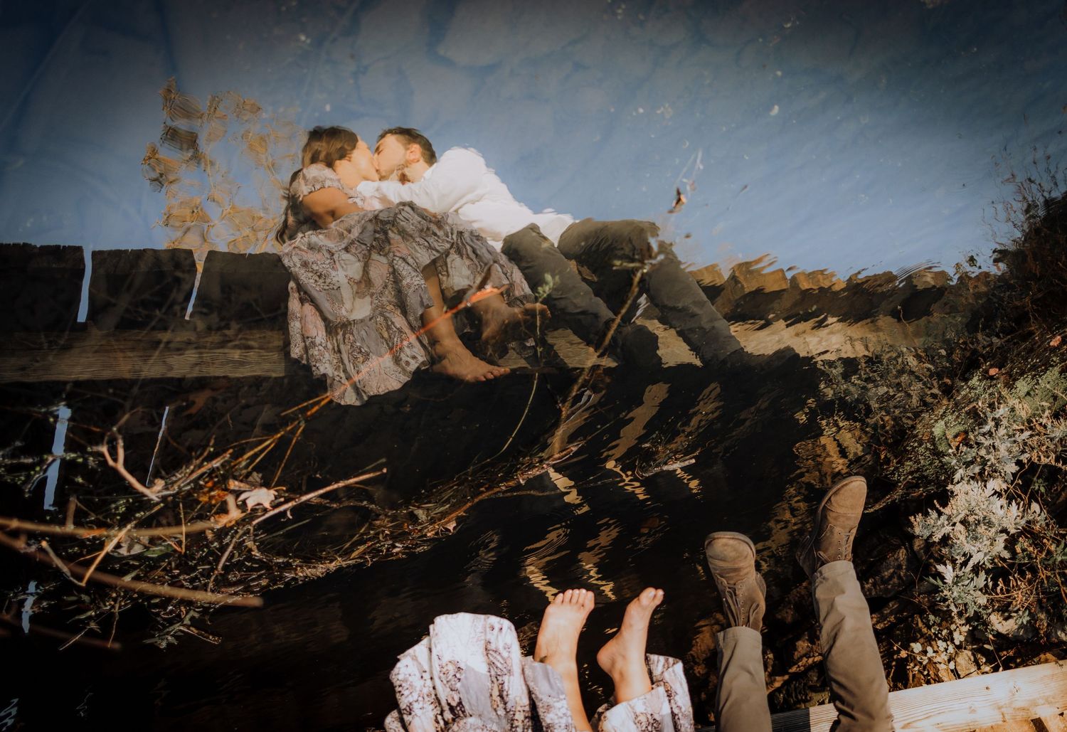 A couple shares an intimate moment together in a rustic outdoor setting during golden hour.