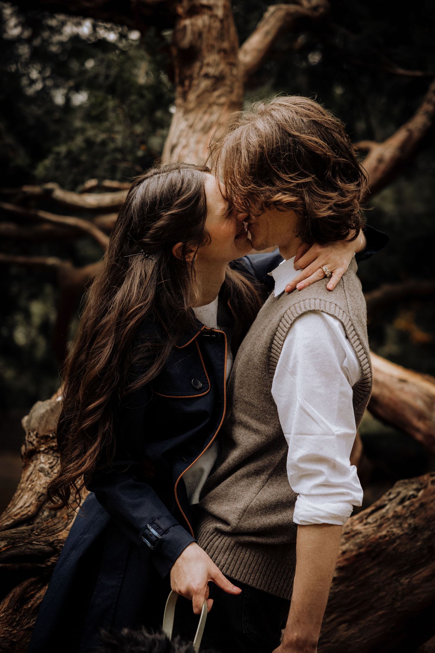 Intimate forest photoshoot with natural lighting and autumn colors.
