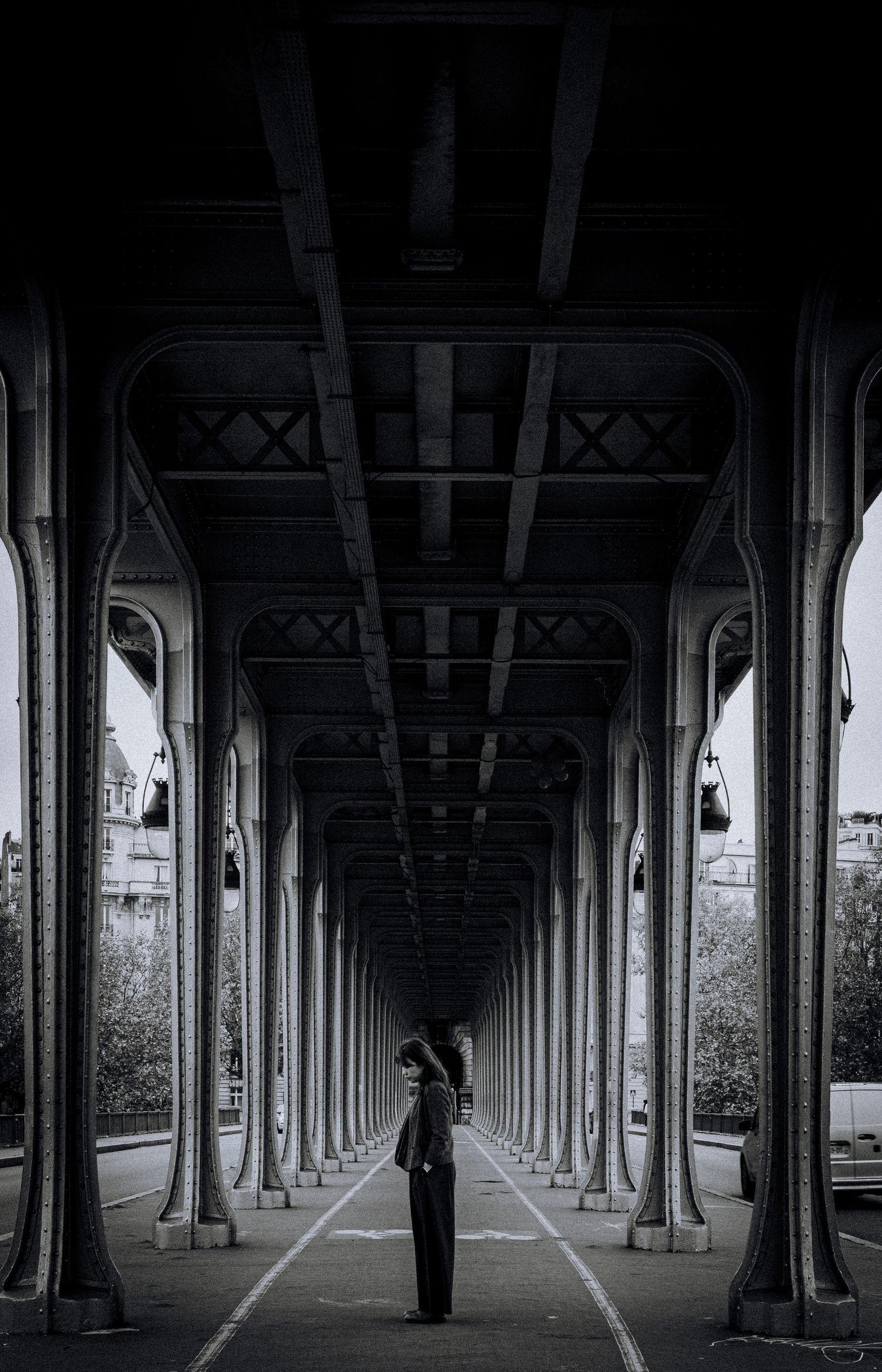 Architectural black and white photo of symmetrical bridge columns creating leading lines.