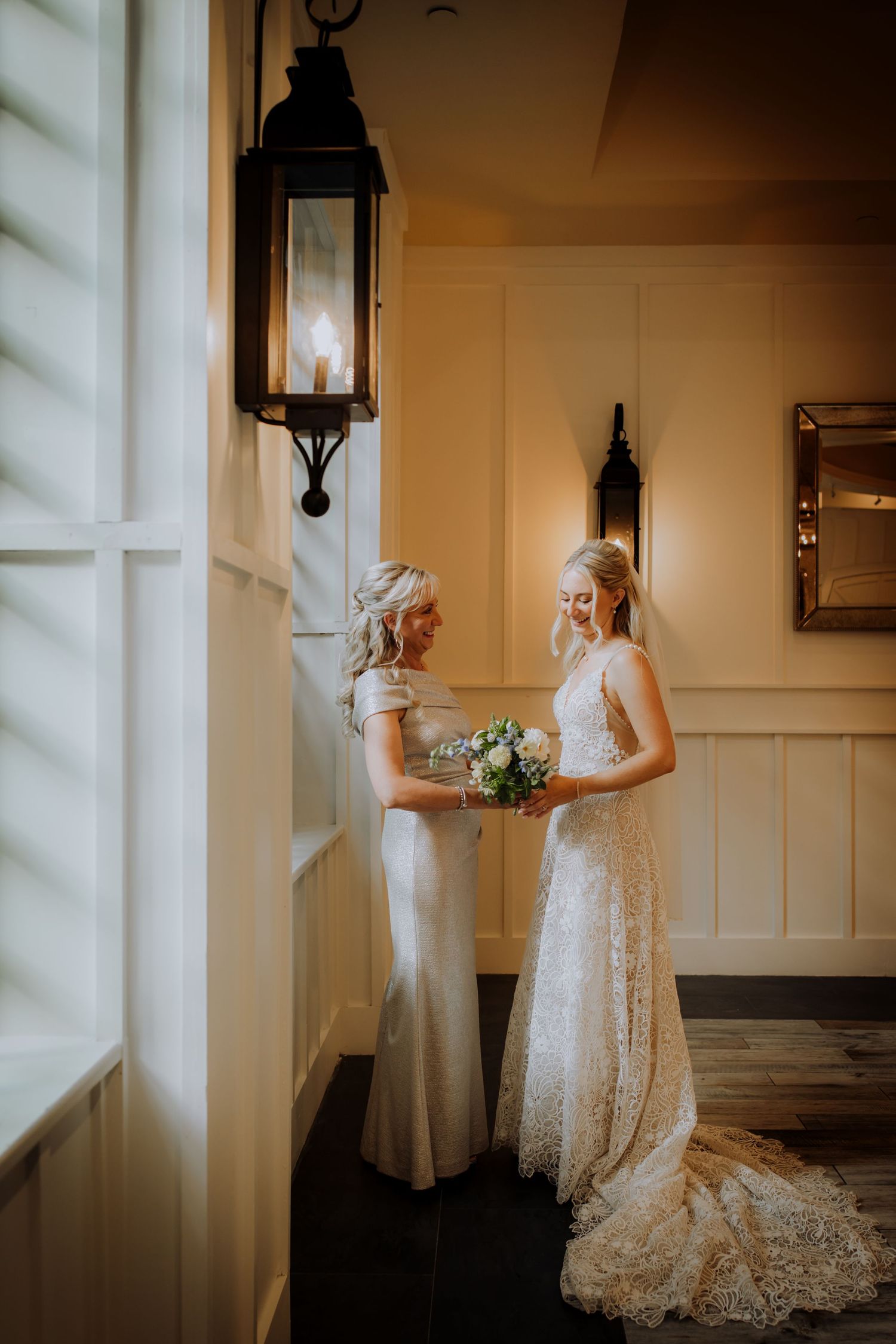 Elegant bridal portraits in a softly lit room with vintage decor and window light.