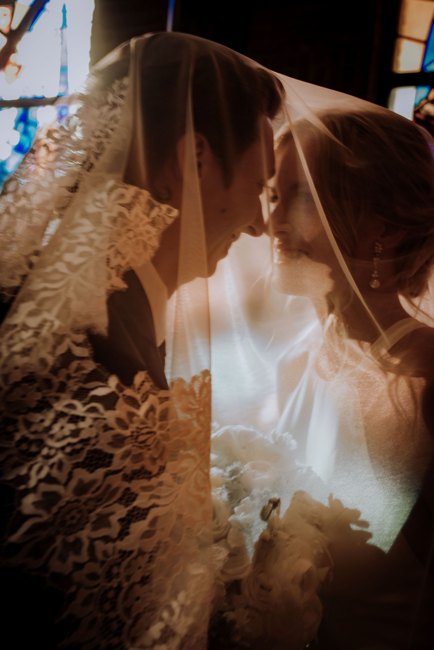 Artistic close-up shots of intricate lace wedding dress details with soft lighting.