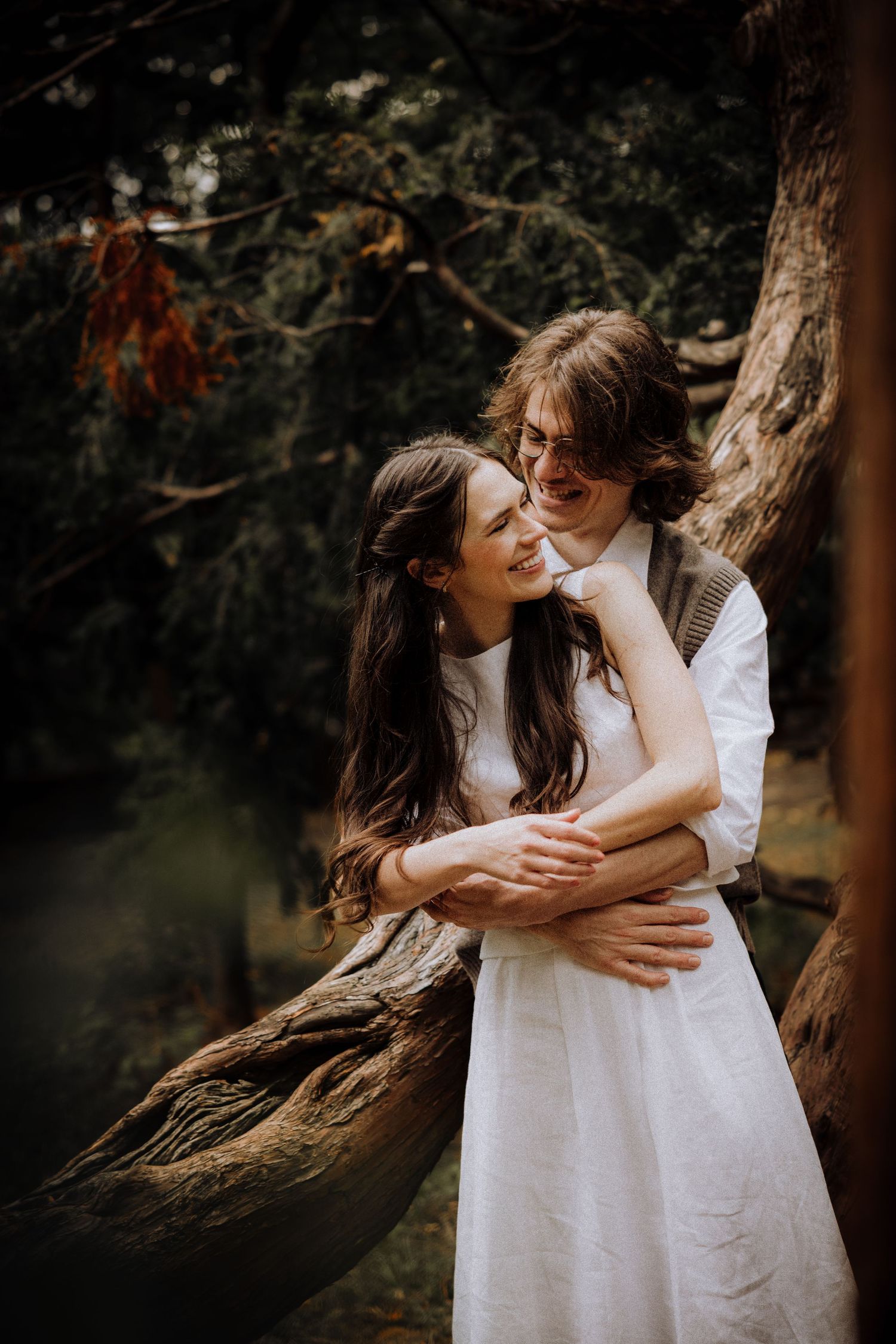 Candid moment of laughter and embraces against a natural backdrop.