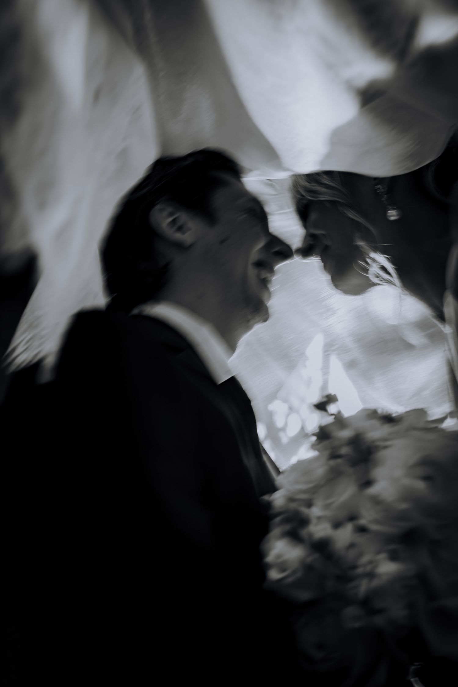 An artistic black and white wedding portrait capturing a tender moment.