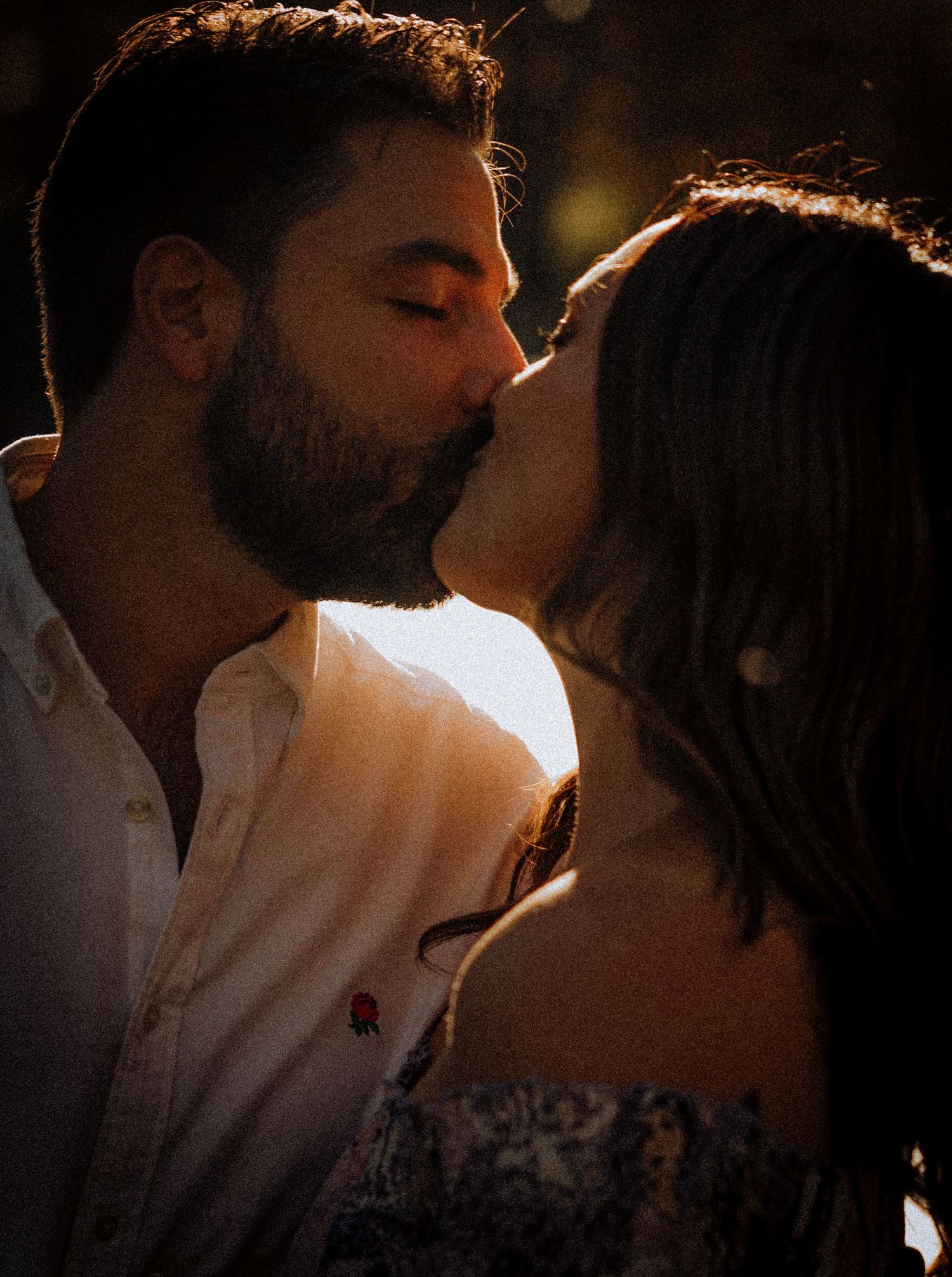 Intimate silhouette of a romantic moment backlit by warm sunlight.