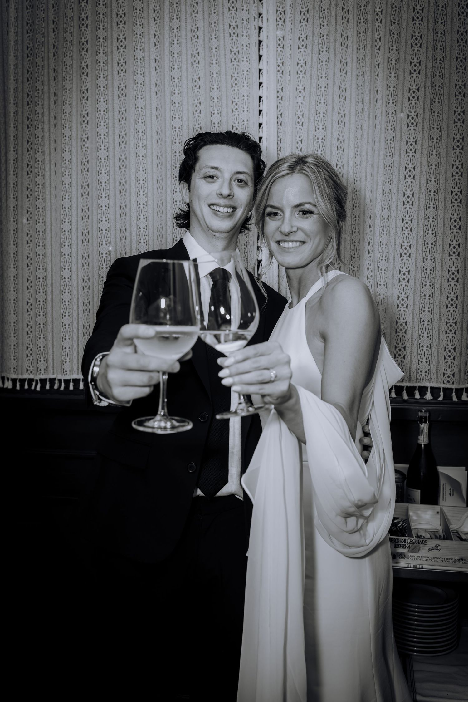 Guests raise wine glasses in a celebratory toast at a formal event.Editorial and Cinematic Wedding photos