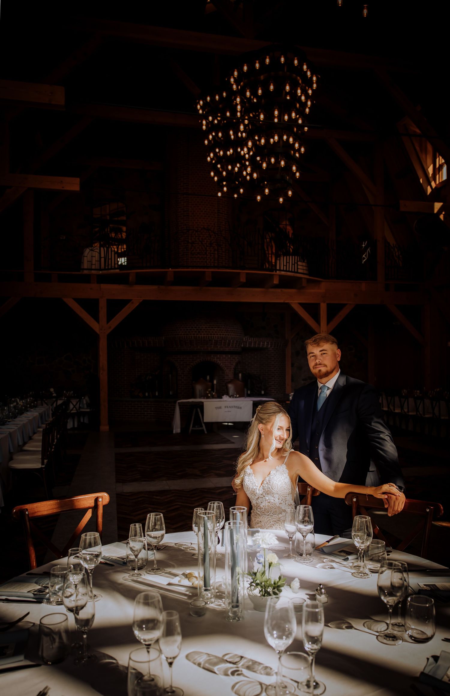 Wedding reception venue with dramatic hanging lights and elegant table settings.Editorial and Cinematic Wedding photos