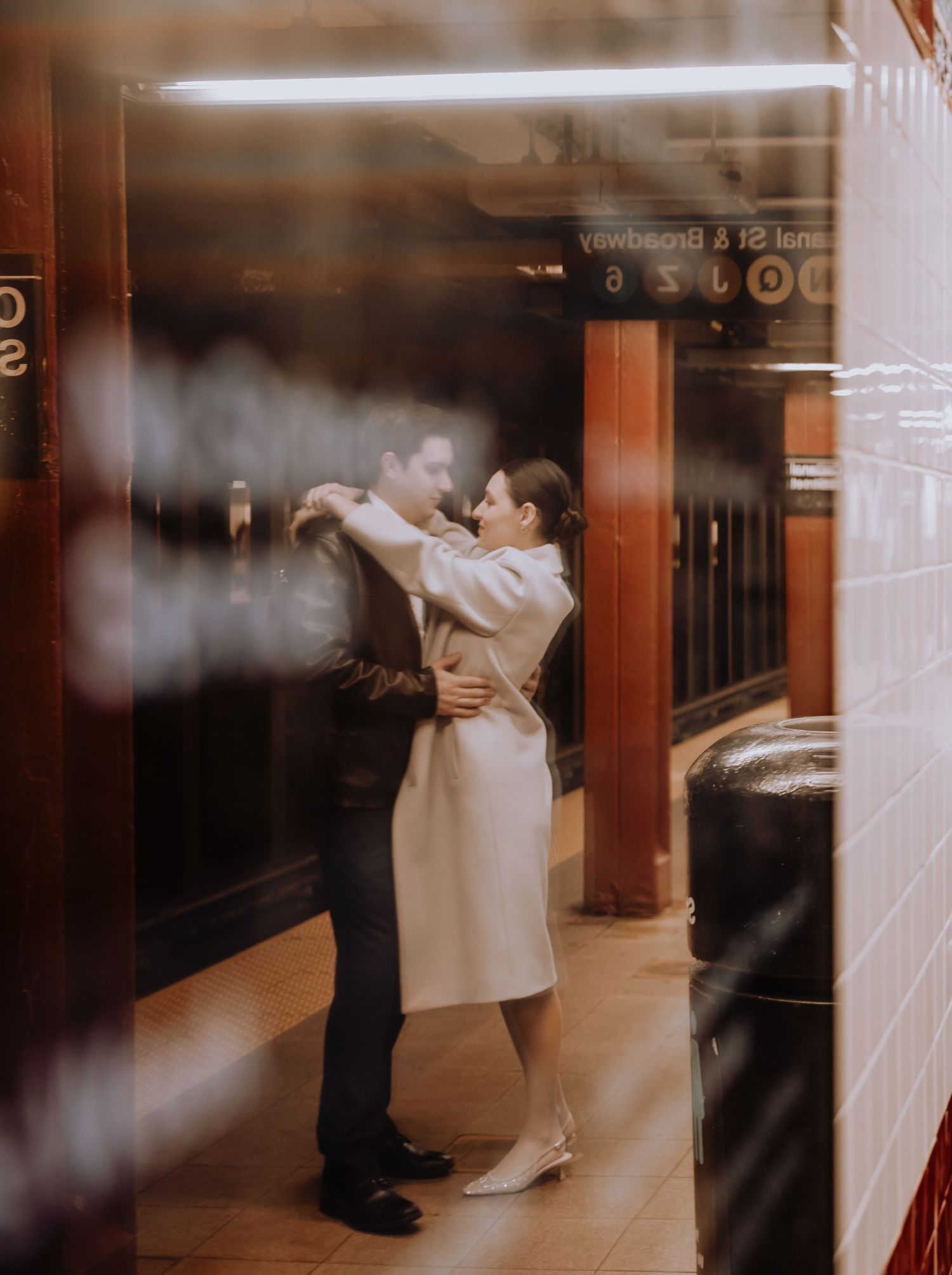 Intimate moment captured in a vintage-style subway station setting.
