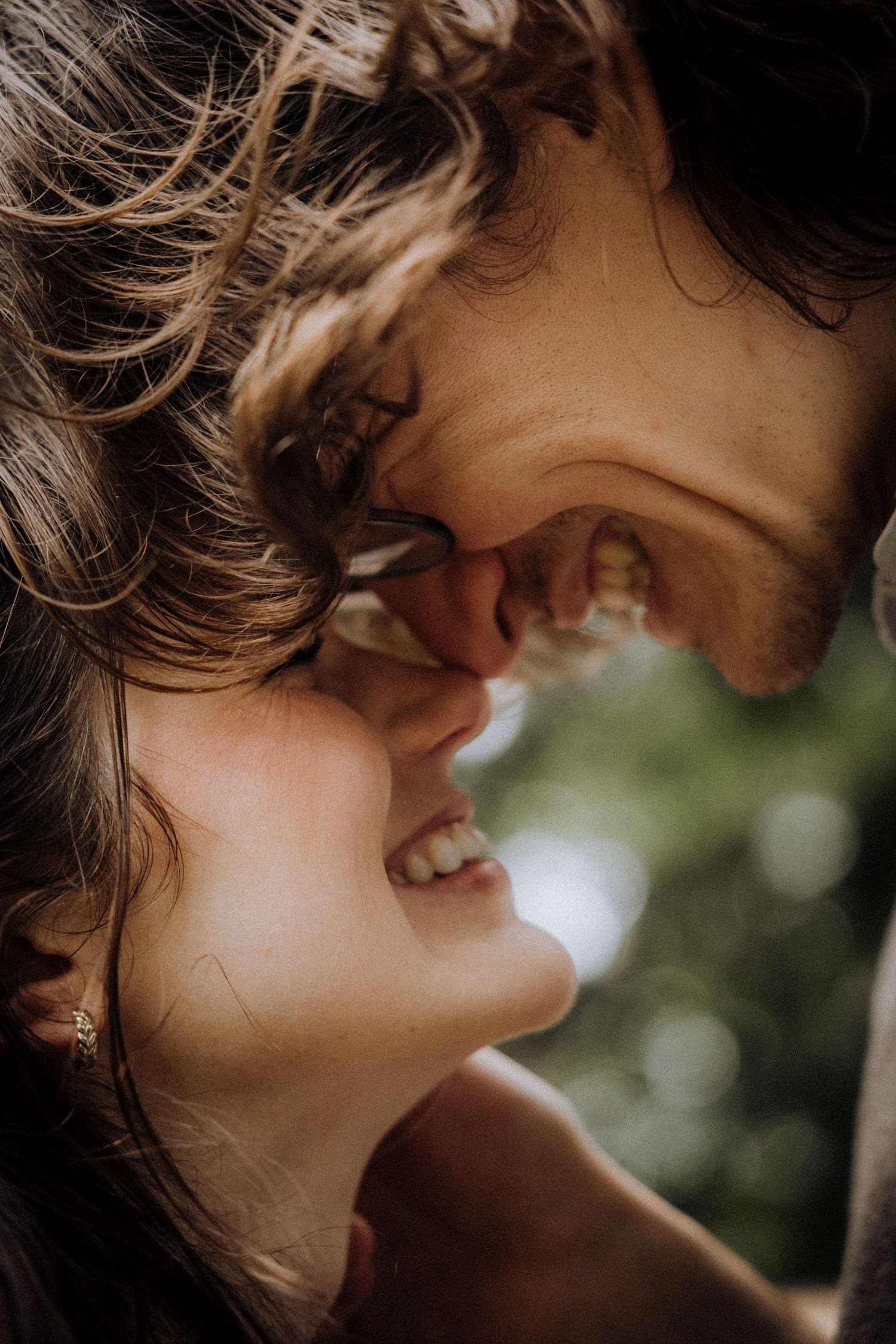 Close-up artistic portrait showing intimate expressions in natural light.