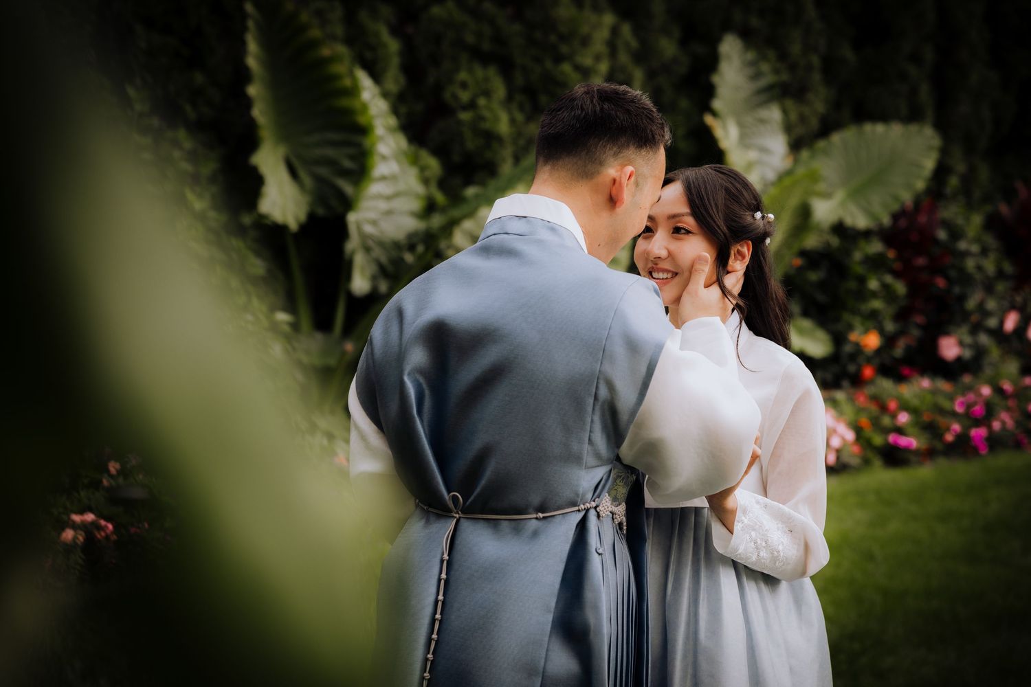 Intimate wedding photo session in a lush garden setting with soft lighting.