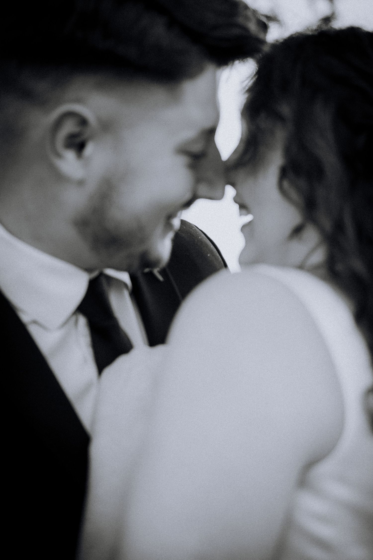 Intimate black and white portrait of couple in soft focus.