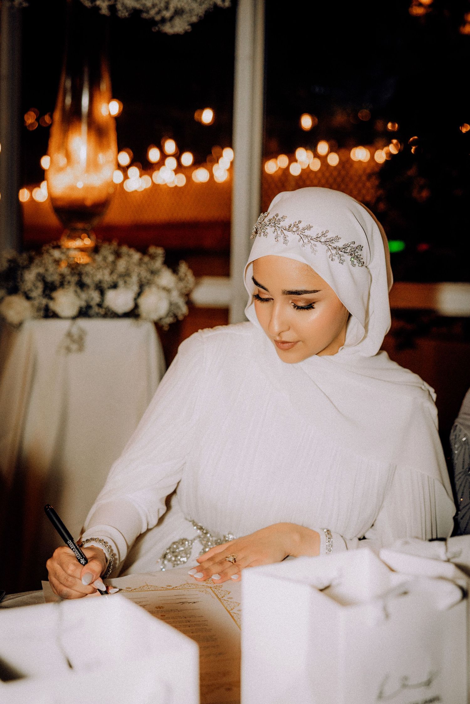 Wedding ceremony documentation with elegant white attire and traditional details.