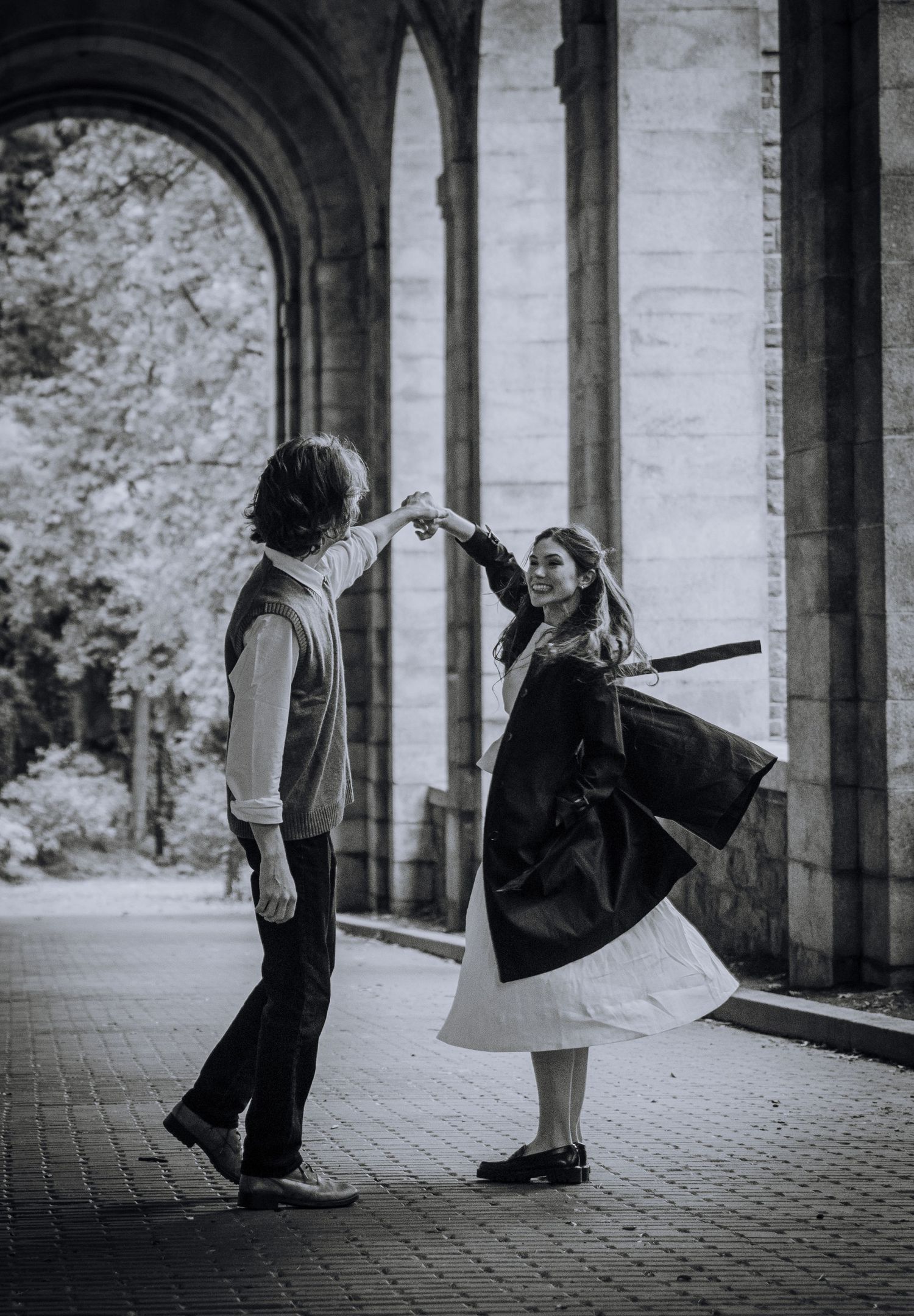 A romantic vintage-style dance scene under stone arches with flowing dress movement.