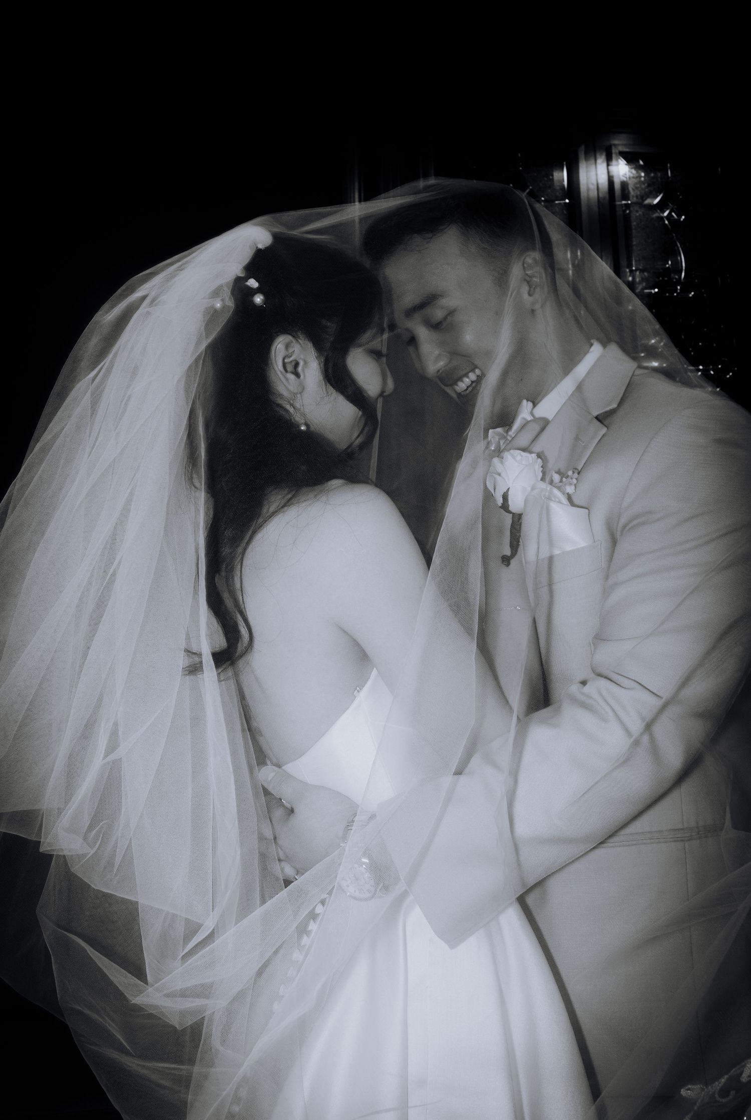 Intimate black and white wedding portraits showing tender moments between newlyweds.