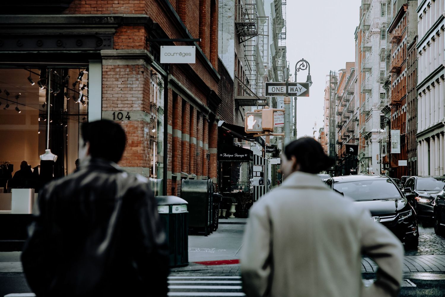 Urban street scene with buildings and city architecture in muted tones.