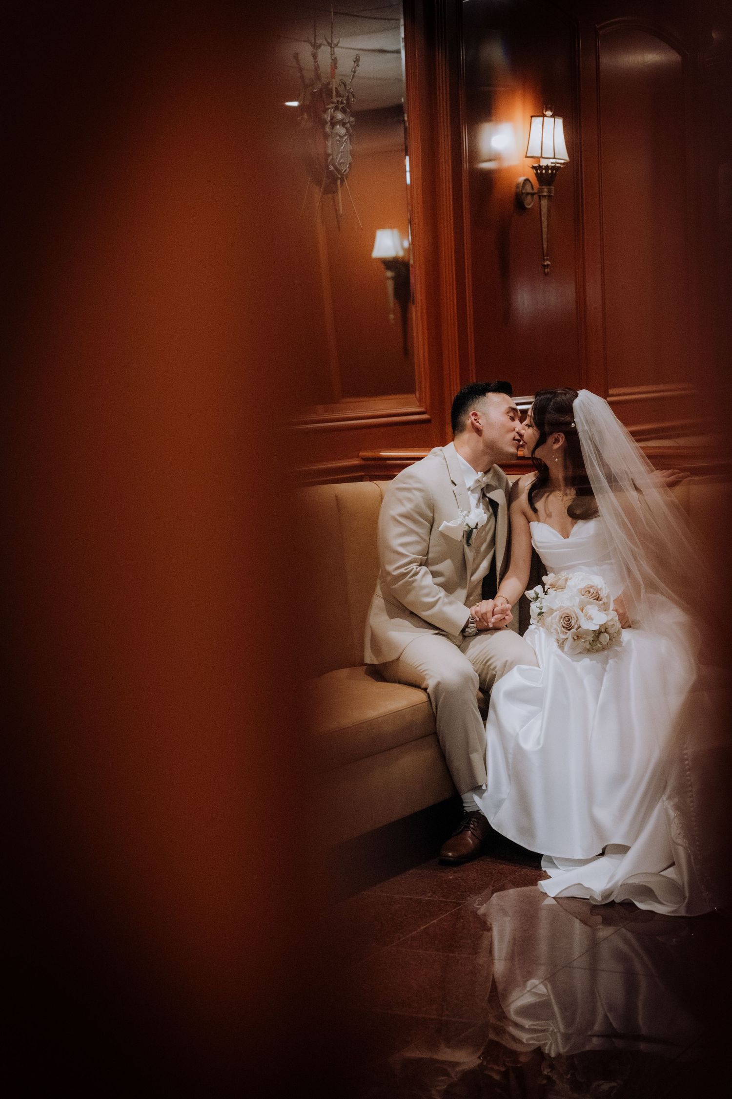Intimate wedding portraits in warm-toned room with classic wood paneling.