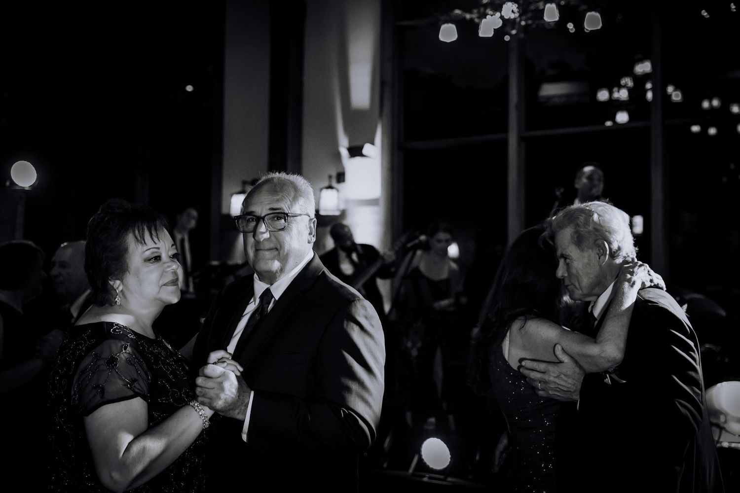 Dramatic black and white dance floor moments captured at a wedding reception.