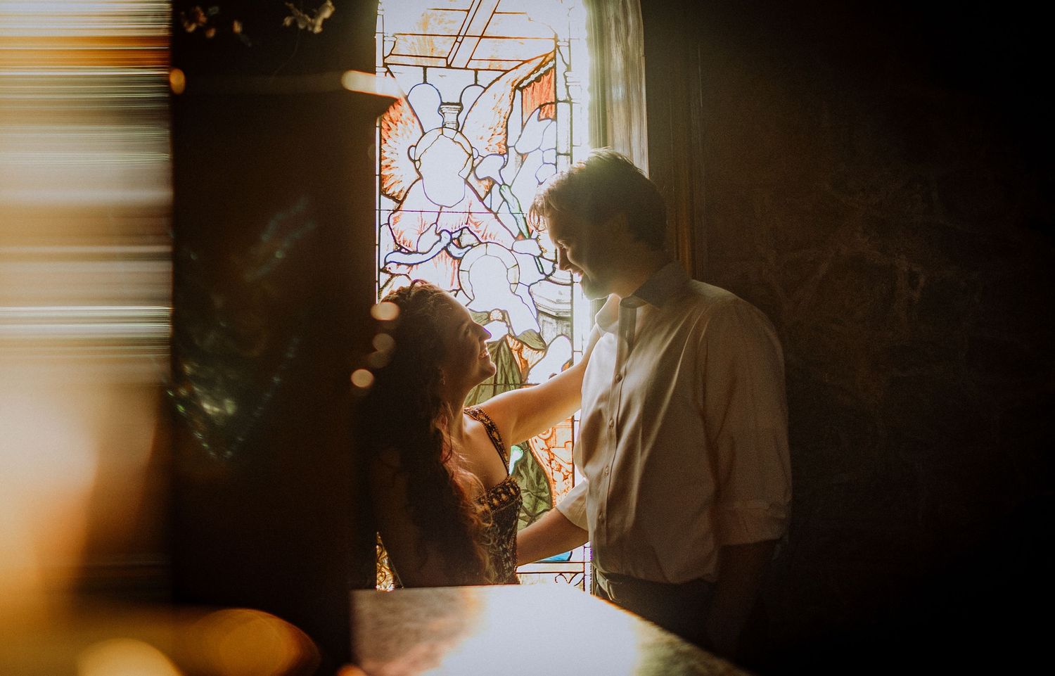 Ethereal light streaming through a church window creating dramatic shadows and ambiance.