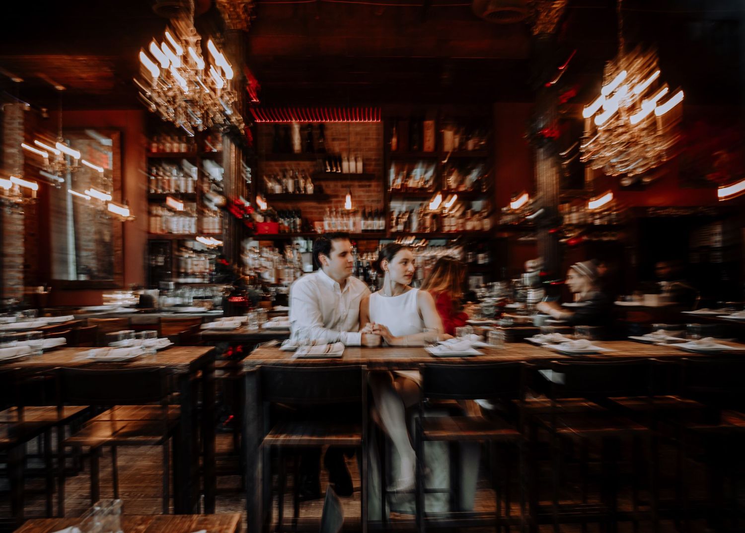 Elegant restaurant interior with warm lighting and crystal chandeliers creates an intimate ambiance.
