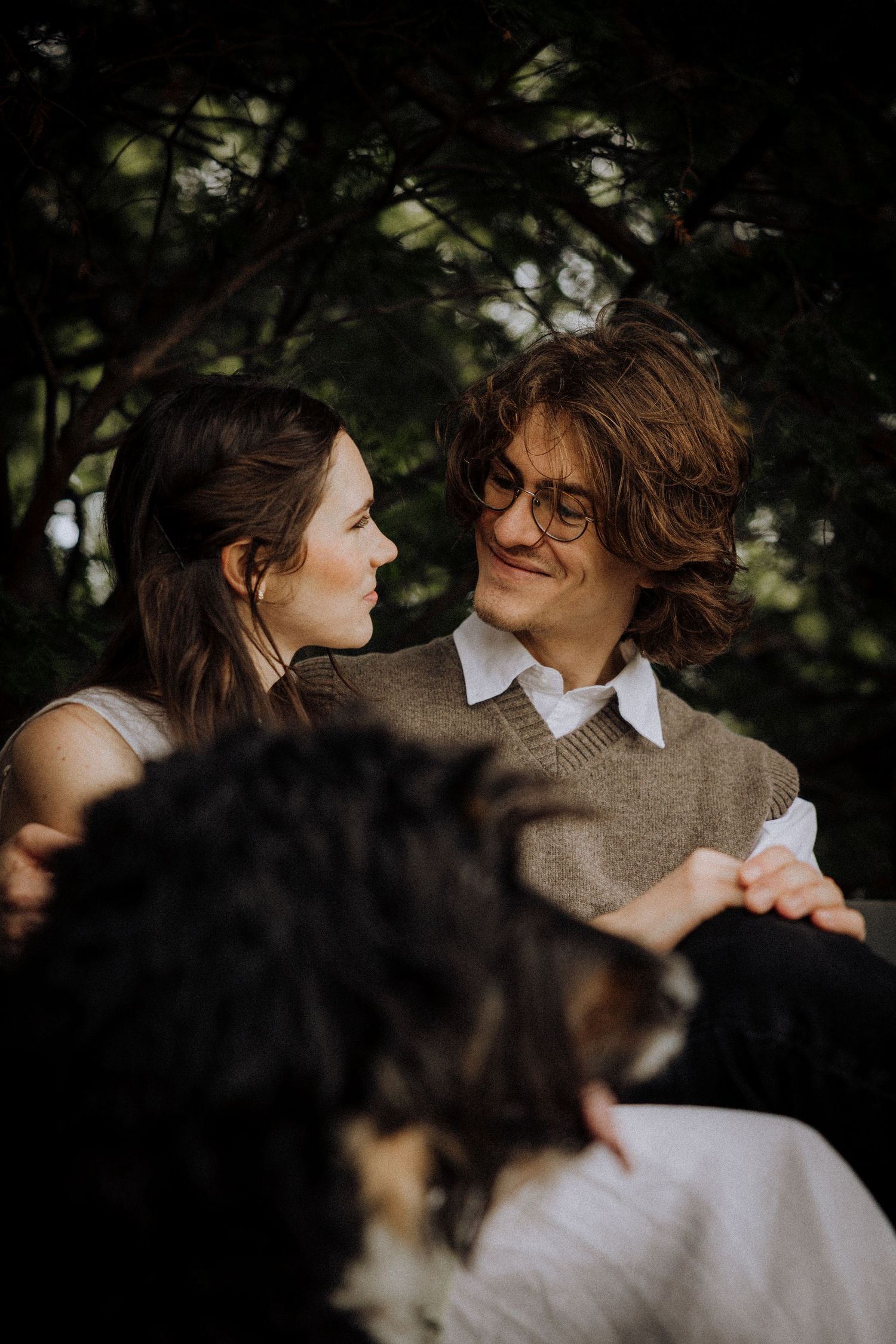 Intimate close-up shots of a couple in casual attire sharing tender moments outdoors.