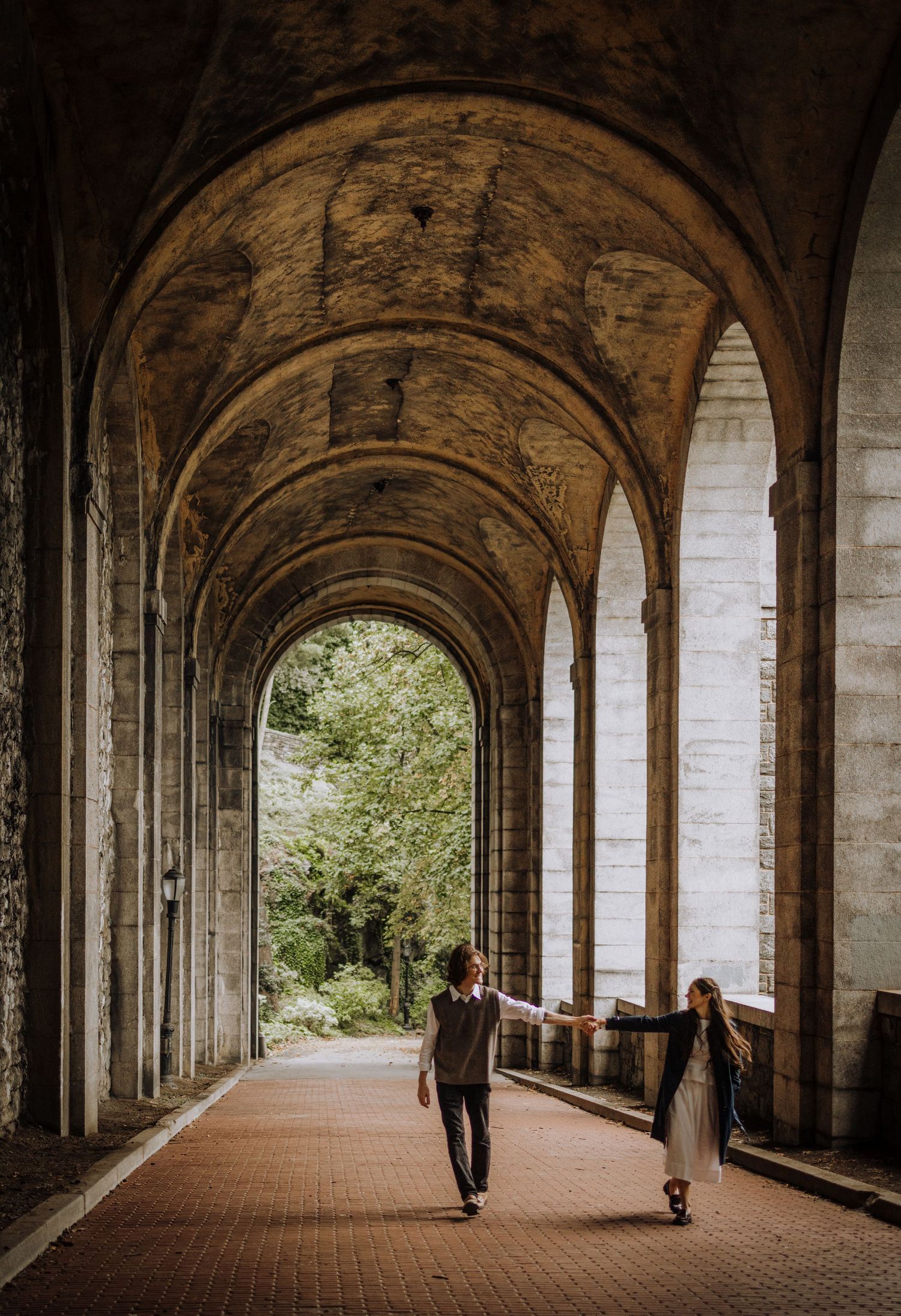 Beautiful arched stone colonnade with dramatic lighting and perspective.