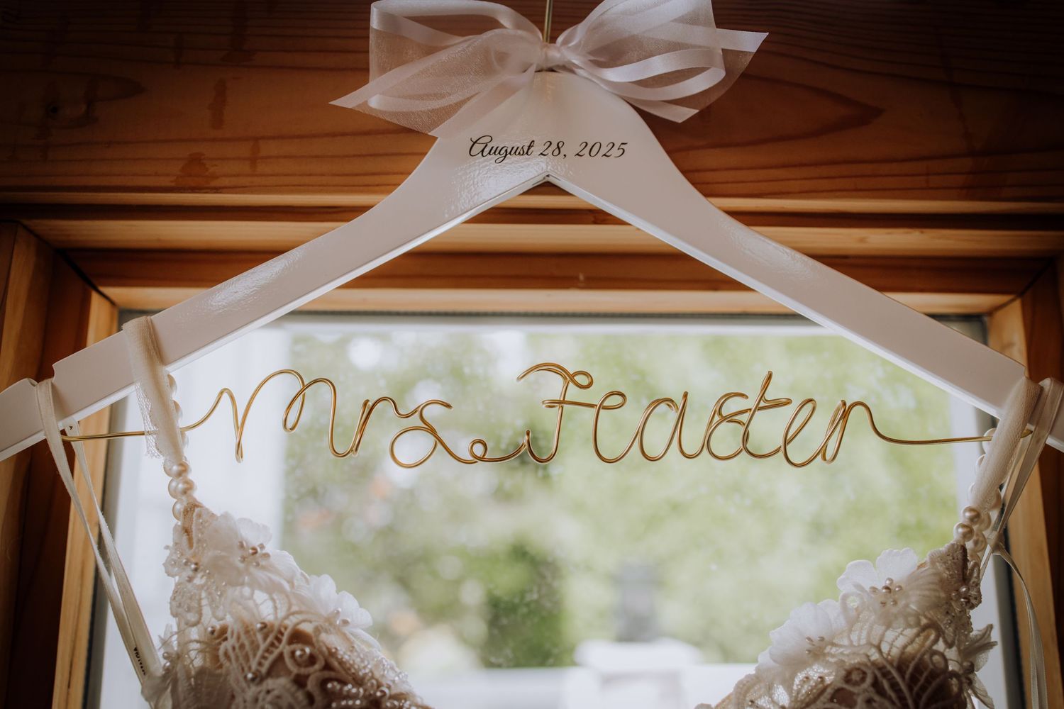 A personalized wedding dress hanger with 'Mrs. Pealer' written in gold wire.Editorial and Cinematic Wedding photos
